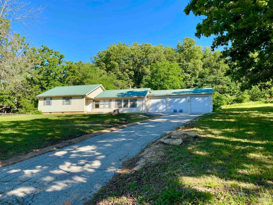 3BD/2BA home with 2 living areas and 3 car garage. The home has 1860 sq ft with Central HVAC heat pump has propane back up plus 2 ventless heaters. The eat-in kitchen includes propane range, dishwasher, disposal and refrigerator. Large formal living room and most of the home has nice laminate flooring. Master suite has mirrored closet doors plus walk-in closet, his/her vanity and shower in the bath area. There are 2 additional bedrooms and the main bath has a full tub/shower unit. Large utility room. 19x24 Family room has ceramic tile flooring and 3 ceiling fans. Oversized 3 car Garage is 36x36 with extra high doors and ceiling. Plenty of room for cars and workshop area. Lot is just under an acre (.76) with scattered trees and mature grass. There is a private 8x19 patio in the back yard that also has access from the family room to the garage. 1000 gallon Propane tank included.