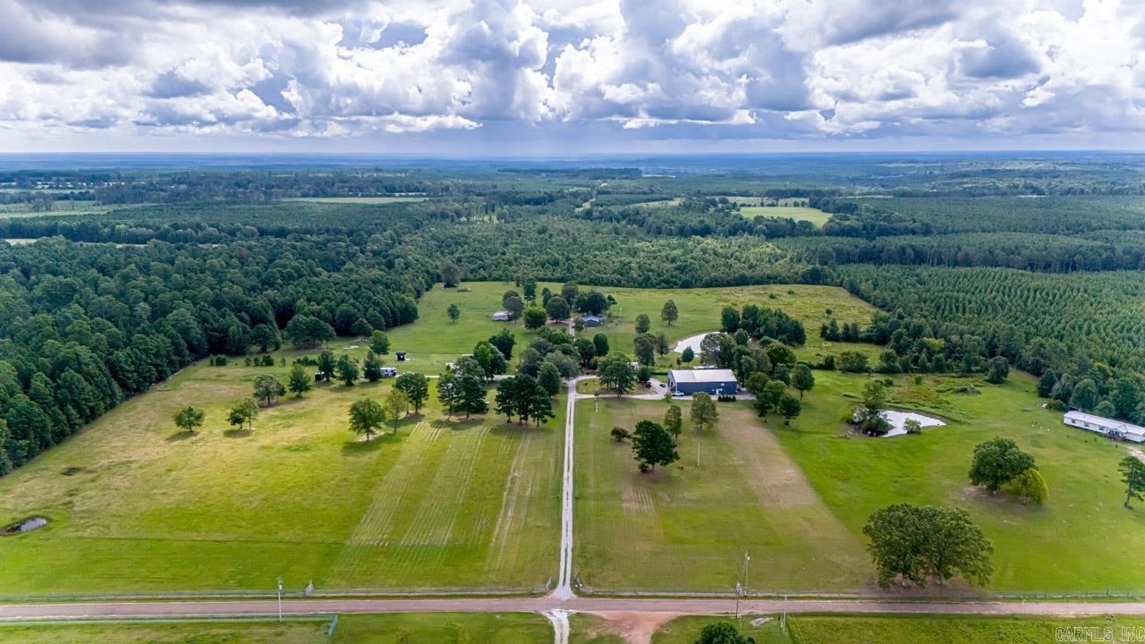 Paradise awaits & is income producing! 3 houses and barndaminium, 5 RV pads w/utilities, 12 tent campsites, bathhouses, dipping pool & more! 78 1/2 acre property is level to rolling w/3 ponds for fishing, fields to roam, great for grazing cows or horses. Setting is truly serene! Barndominium houses the main 3,000 SF dwelling which has 2 main BDrms plus 1BD/1BA Ahave Apartment & 1BD guest Shalom Suite! Main house has pine floors, beautiful windows 2022, incredible chef's kitchen w/Thor range, double ovens, massive laundry/pantry & breathtaking porches! An additional quaint 2BD/1BA home sits on property plus a mobile home on permanent structure - completely remodeled'24 Jubilee Cottage & has big porches! Property also includes a 2024 tiny Yachov House w/2BD/1BA w/detailed wood ceilings, 3 porches, graveled patio, fire pit. PrimaryBD has view of lg pond & private deck. Property has total of 11BD/7BA plus 16x16 greenhouse. Setting is serene! See 4 of 5 dwellings:Shalom Suite at Jubilee Farms, Ahave House at Jubilee Farms, Yachov House at Jubilee Farms, Jubilee Cottage all in Leola, AR can be seen in full photos on Airbnb or Hipcamp platforms... Must see for qualified Buyers!