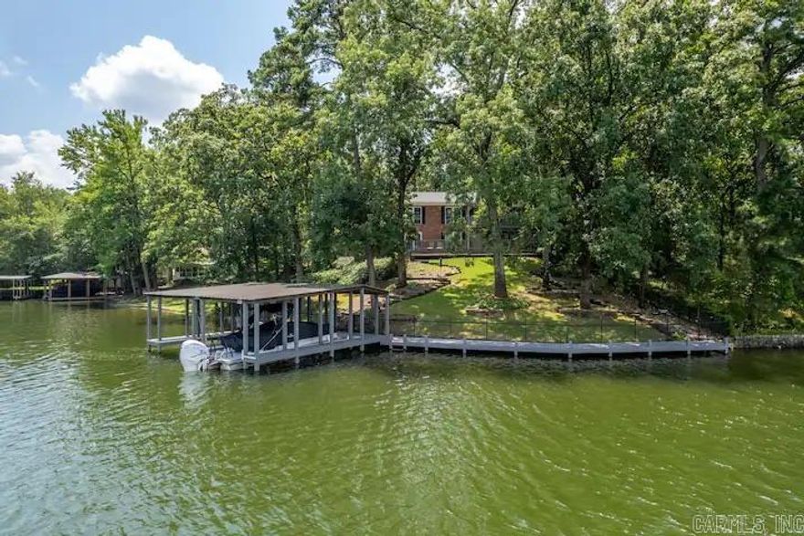 Investors...Must see this recently updated lake home nestled at 102 Oak Point Drive on beautiful Lake Hamilton with approximately 103' lakefront. This  4 Bedroom 3 Bath Home features open floor plan with expansive decks. The home has 2 stall covered boat dock with boardwalk. Two spacious kitchens and living areas that open to dining area with beautiful lake views. The property is an active nightly rental, but would also make a perfect family lake home!  Home is being sold furnished. NO SPD. Owner has never lived in the property. Show dates are scheduled around guest. Call today for your private showing! New roof will be put on soon.