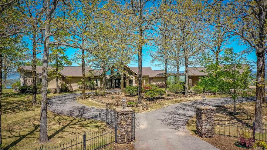 This is a rare opportunity to own a truly one-of-a-kind property, offered to the market for the very first time. Thoughtfully custom-built, this home is perfectly positioned on the bluff to capture breathtaking panoramic views from every room, including stunning sights of the Narrows Bridge, Greers Ferry, and beyond. Located within a gated subdivision, the property offers both privacy and peace of mind. The home is designed for convenient single-level living, featuring low-maintenance finishes. Generac generate backup for essential things in home and garage doors. A breezeway seamlessly connects the main residence, guest apartment, and garage with total under roof sqft over 5,900. The main home includes 4 bed/2.5 bath. The quest house offers full living area, kitchen, bedroom and full bath. A washer hookup is also available in the garage for added flexibility. The home is serviced by city water but does have a well over 400 feet deep, suitable for irrigation or gardening needs. Properties of this caliber and uniqueness are seldom available and must be experienced in person to fully appreciate its exceptional setting and design. Agents, please see all remarks.