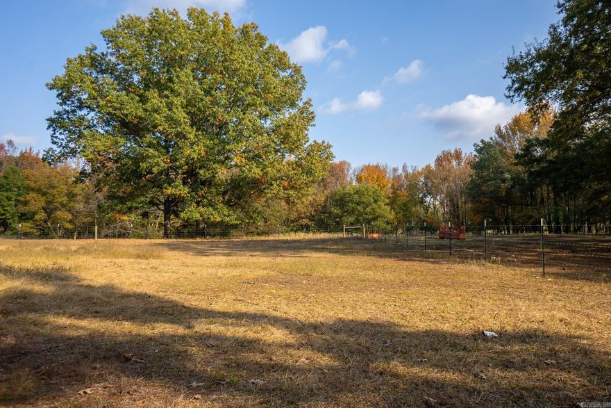 Discover 22.1 acres of open opportunity right here in Jacksonville, AR. The land is cleared, fully fenced, and includes approximately 5.4 +/- acres of pasture, a riding arena, stable, and a barn/shop—ready for a wide range of uses. A 952 sq. ft. mobile home sits on the property and offers 1 bedroom, 1 bath, with updated flooring, and a newer metal roof. Whether you’re utilizing the existing structures or planning to build, this property gives you flexibility and room to grow, all while sitting on a rise, set back from the road, offering privacy and a peaceful setting that’s tucked out of sight..