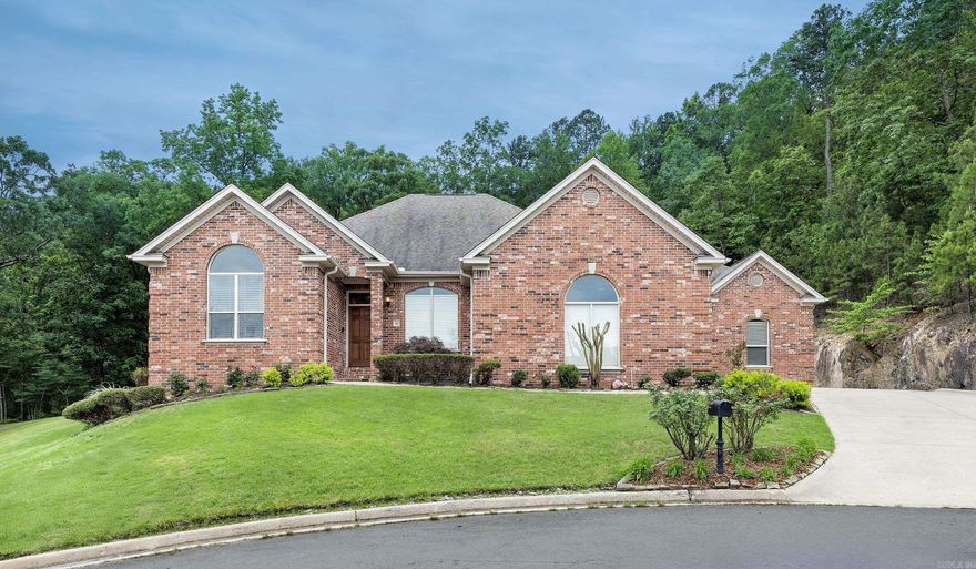 Freshly Painted Interior and Move in Ready!!! 110 Clervaux is nestled in the highly desirable Chalamont Place neighborhood of Chenal Valley. This stunning home sits on a quiet cul-de-sac with green space along the back and side, offering exceptional privacy and serene natural views. With 4 bedrooms on the main level and a flexible 5th bedroom or bonus room upstairs, the layout is perfect for entertaining. The spacious kitchen features double ovens, a center island, and opens to a bright breakfast area and cozy den. Enjoy formal dining, soaring ceilings, and an abundance of natural light throughout. Step outside to a covered patio and beautifully landscaped backyard—ideal for outdoor living and entertaining. Relax on the charming front porch and take in the picturesque surroundings. This home offers the perfect balance of comfort, privacy, and elegance. 3 NEW AC UNITS installed! Don’t miss your chance to call it yours—schedule your private showing today!