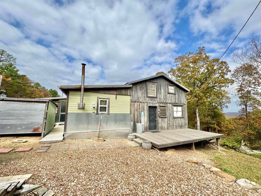 This is a beautiful property in the country just outside of Mountain View. It is listed as a 2-bed, 2-bath, However, in the upstairs area there is plenty of room for more bedrooms/sleeping space. It also includes a mother In-Law suite perfect for guests, an office, or workshop. The property has multiple out buildings. Some are for storage, some for firewood storage, a chicken coop, and an old home. The old house is falling down and does not hold much value, but some materials from it may be reusable. There is also a beautiful garden area that is fenced in, and has lots of varieties of flowers, plants, and fruit trees. The main house offers a new central heat and air system as well as a walk-in closet, gas and wood burning ranges, built-ins, office and storage space, and a separate laundry room. Just a short drive away from the town of Mountain View, and all the local amenities. Which included, restaurants, shopping, hiking trails, The White River, and The Ozark Folk Center State Park, and so much more. This is definitely a one-of-a-kind property and is a must see. Call today to set up an appointment.