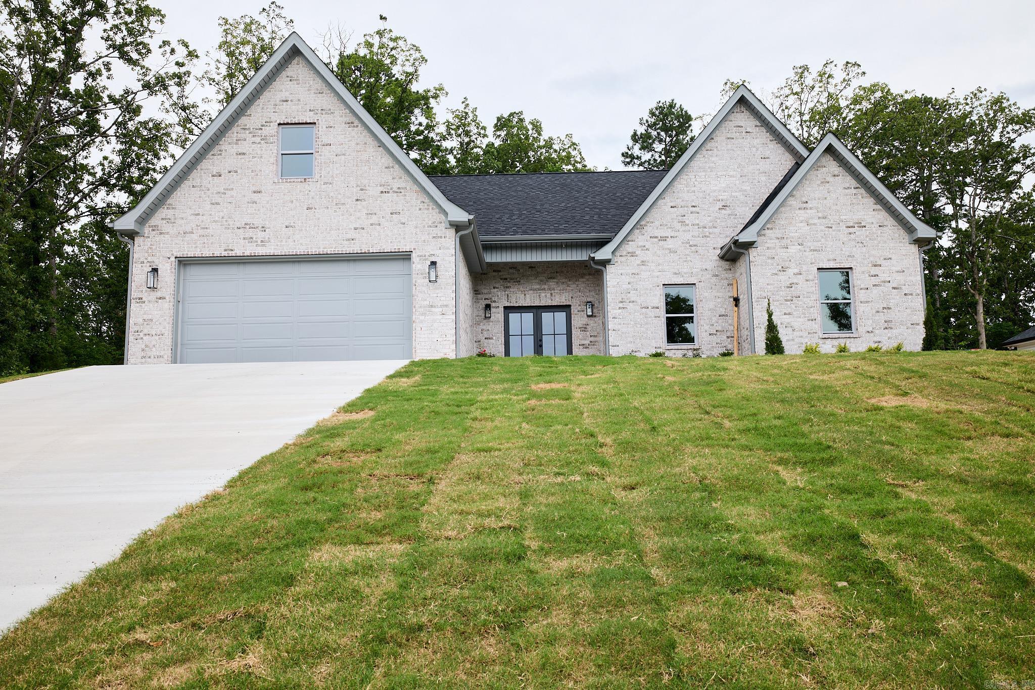 NEW CONSTRUCTION in the lovely Hidden Forest community in LHSD! You MUST SEE this stunning modern home with spacious open concept design! The island kitchen is at the heart of the home. You will fall in love with the Taj Mahal Countertops and champagne bronze hardware adorning the custom cabinetry. You will be surrounded by elegant finishes and contemporary elements throughout! The large laundry room features built-ins enhancing functionality. The overall design radiates a modern and welcoming atmosphere, perfect for contemporary living. The Primary suite with walk-in closet, has an inviting soaker tub and custom shower!