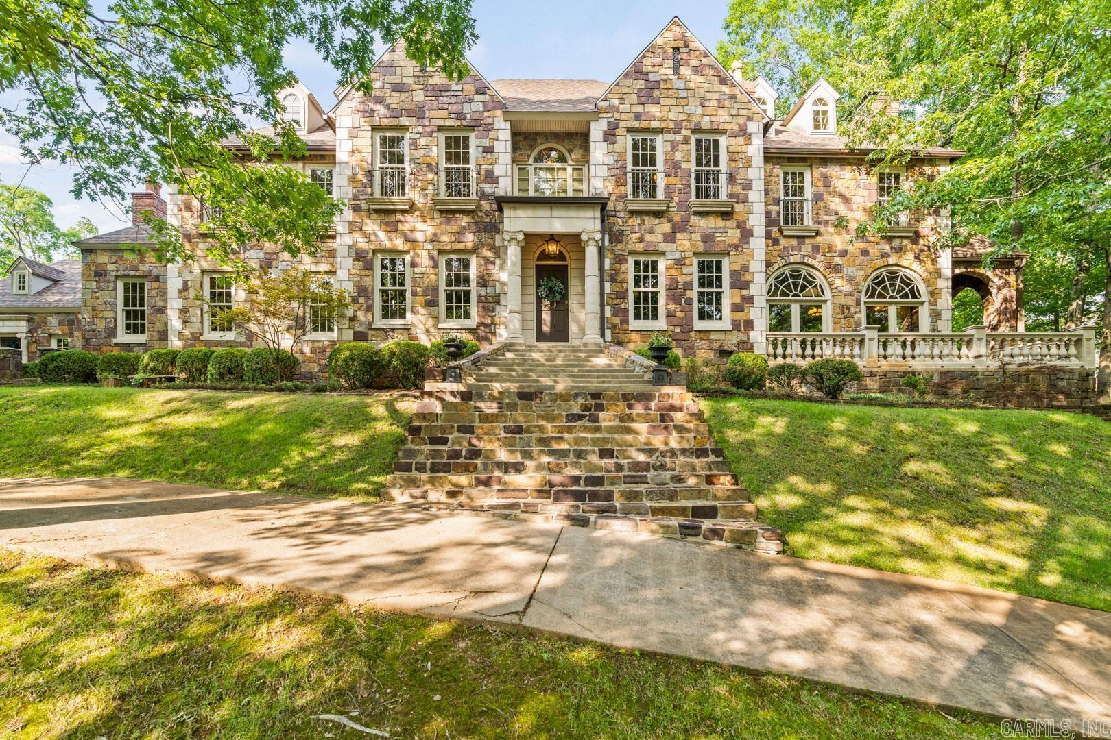 Magnificent English Estate in the country with beautiful views of surrounding property! Yet just minutes from the Promenade. Gorgeous stone exterior home with attached two car garage with exercise room above, plus a separate 2167 sq ft heat and cooled 9 car garage / shop. Charming 2 story stone fully functioning guesthouse all on 5+ acres on the western edge of town in a picturesque rolling hill setting with creek. Exquisite family home that has stunning imported woodwork and built ins throughout. Generator, 5 Fireplaces, hardwoods, gorgeous stone, tile and carpet floors with beautiful modern amenities. Porches galore. Recent updates include new hardwoods upstairs in hallway and primary bedroom and downstairs hardwoods refinished. Fresh paint in the main house and the biggies....New roof on main house and nine car garage AND all new HVAC in all the buildings. Gorgeous piece of property with a fabulous gate entering the property. Make an appointment to come see this beauty.