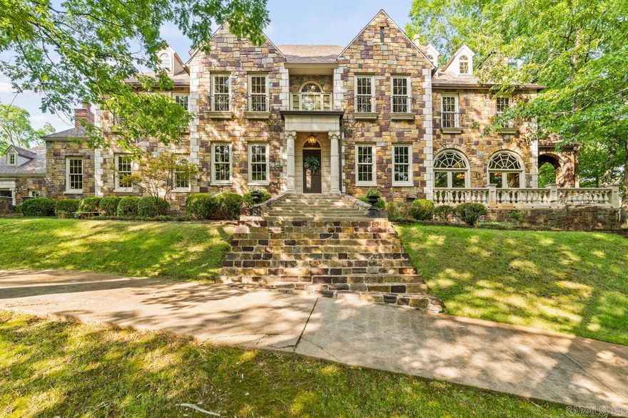 Magnificent English Estate in the country with beautiful views of surrounding property! Yet just minutes from the Promenade. Gorgeous stone exterior home with attached two car garage with exercise room above, plus a separate 2167 sq ft heat and cooled 9 car garage / shop. Charming 2 story stone fully functioning guesthouse all on 5+ acres on the western edge of town in a picturesque rolling hill setting with creek. Exquisite family home that has stunning imported woodwork and built ins throughout. Generator, 5 Fireplaces, hardwoods, gorgeous stone, tile and carpet floors with beautiful modern amenities.  Porches galore.  Recent updates include new hardwoods upstairs in hallway and primary bedroom and downstairs hardwoods refinished.  Fresh paint in the main house and the biggies....New roof on main house and nine car garage AND all new HVAC in all the buildings.  Gorgeous piece of property with a fabulous gate entering the property.   Make an appointment to come see this beauty.