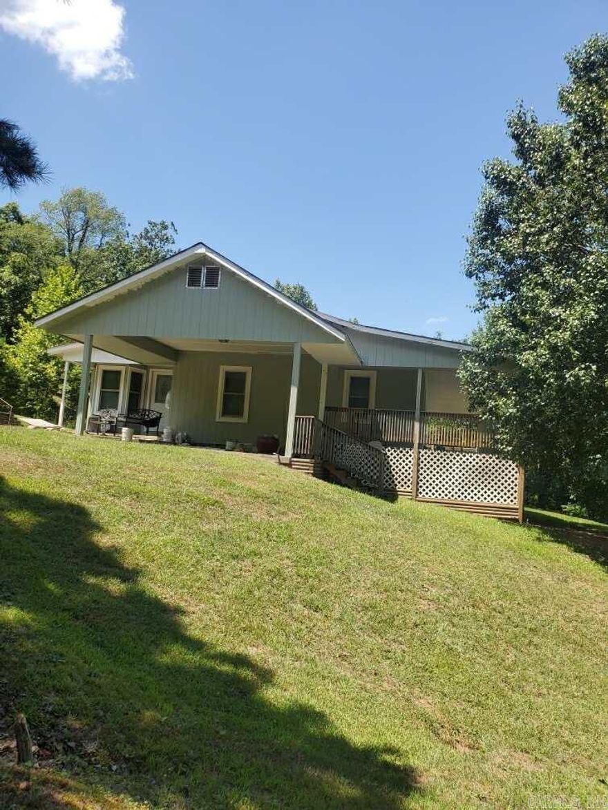 LOCATED at the entrance to the Ouachita National Forest on Arkansas State Highway 375 East and on the road to the Shady recxreational areas and the Wolf Pen ATV trails.  This property is 6 acres with a 3 bedroom, 1 bath home in 1378 square feet with a carport plus a 20' X 24' detached garage.  It features central heat and air conditioning with heat pump, new roof about 5 years ago, new insulated glass windows in early 2024.  The covered front porch looks inviting. The land runs deep away from the highway, allowing lots of room for hunting, hiking, ATVing and other activities.  If you need a permanent home or a home away from home or a rental home, this propety should be worth a look.  Some of the furnishings may be negotiable.