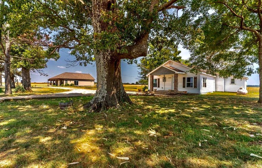 Rare Find! This property truly has it all—two charming homes on one spacious lot, offering endless opportunities for multi-generational living, a guest retreat, or rental income. The main bungalow-style home offers 2 bedrooms and 2 bathrooms with vaulted ceilings accented by a wood beam, creating warmth and character. An open-concept living area makes the perfect space for gatherings and holidays. The spacious primary suite includes a walk-in shower and oversized closet for comfort and functionality. The second Traditional Farmhouse features 2 bedrooms, 1 bathroom, and a flex room that can be used as an office, craft space, or hobby room. Its large kitchen is designed for entertaining, complete with granite countertops, gas stovetop, backsplash, and vent hood. Recent updates include a remodeled bathroom, new roof, and new AC unit within the last two years. Nestled in a peaceful country setting, yet only 11 minutes from Brookland School District, this property offers the best of both worlds—quiet rural living with quick access to town.