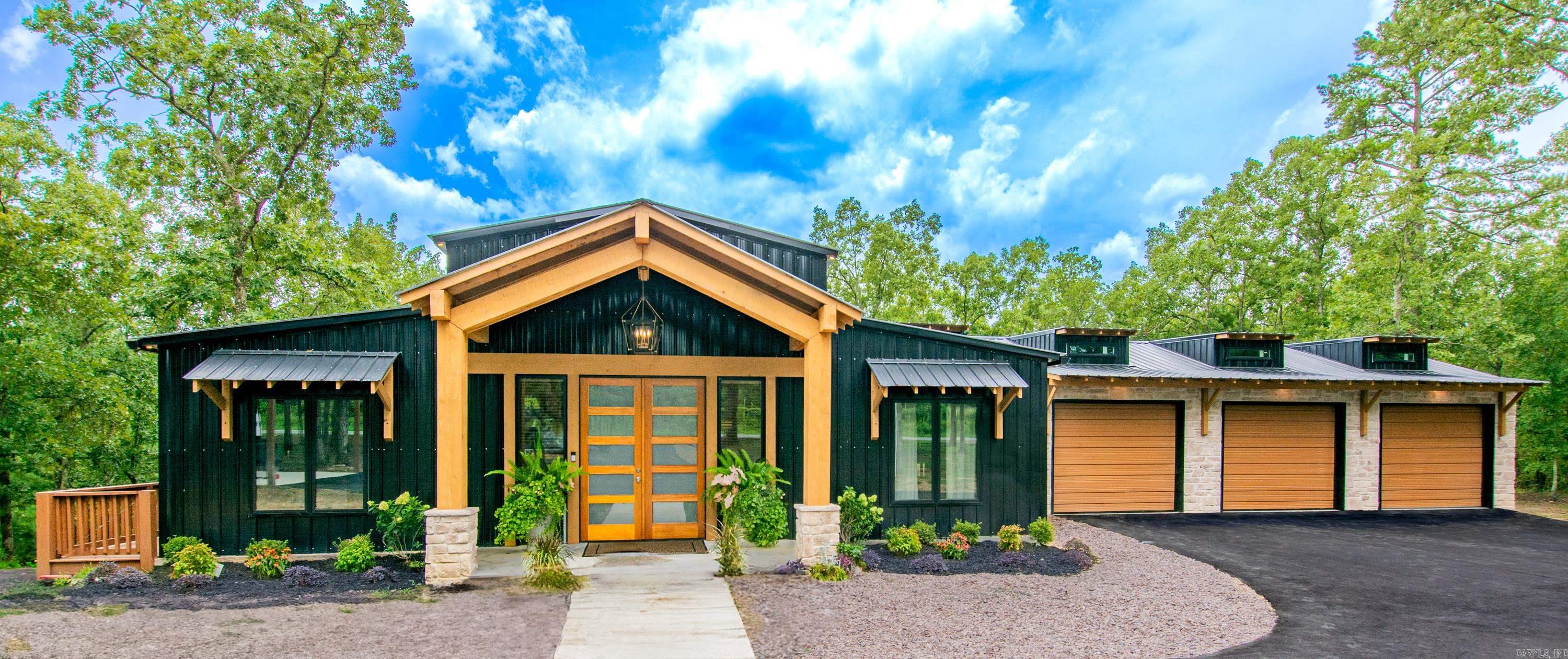 Modern meets Farm in this exquisite builder owned custom home with just the perfect amount of mixed style accents, from the mid-century modern vanities, to the vintage antique bedroom doors. Youāll be greeted with a double door front entrance, grand entryway, soaring vaulted ceilings peaking at 17 feet, and a wide-open floorplan. Guest bedroom with its own en-suite bathroom. Chefās kitchen with butcher block counters, large kitchen island that serves as a breakfast bar, topped with quartz counters, Viking refrigerator and dishwasher, and an abundance of cabinets. Primary suite features vaulted ceilings that peak at 11 feet, spacious closet, and a primary en-suite bathroom with a tub-in-shower combo. Oversized laundry room with built-ins and cabinet storage. 3 car garage to fit all the large vehicles and a 20x40 covered RV pad with full hookups and tie-in to the septic. All this situated on 5.11 acres of mostly wooded property, with a gentle downslope at the back leading to a wet weather creek. Full size deck with wrap around side landing. Metal exterior with cultured stone and cedar accents. Double entry circle driveway illuminates at night with bollard lighting. See Agent remarks.