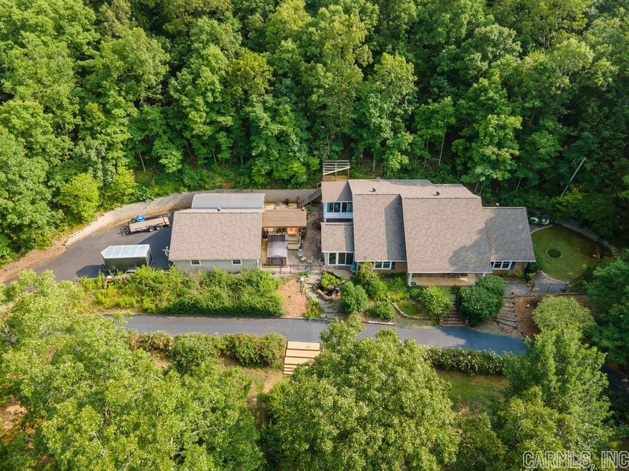 Welcome to your slice of heaven! Stepping onto this property you feel the peace and tranquility provided by the abundant natural gardens, tiered landscaping, and surrounding wooded area. Outdoor living spaces include a pergola with hot tub swim spa, large covered patio with waterfall feature, new upper level deck, and side courtyard. A large primary suite offers its own sunroom with floor to ceiling windows on three sides lending to a wonderful four seasons room.  You will love the walk in Galaxy Deluxe Plus Steam Shower in the primary bath. Check out the link at homewardbath.com  Upstairs you'll find a newly renovated bonus room to include its own kitchenette, full bath, and an upper level sunroom with a new deck across the back.  This space has it's own private exterior entrance. You'll enjoy having the circle drive for all your friends and family when visiting. 30 x 30 - 2 1/2 car garage. This property is where you want to be at the end of each and every day to destress and rejuvenate. Only minutes to Conway and Jacksonville. Ask you lender about the VA Assumable loan to see if you may qualify.  See Agent Remarks