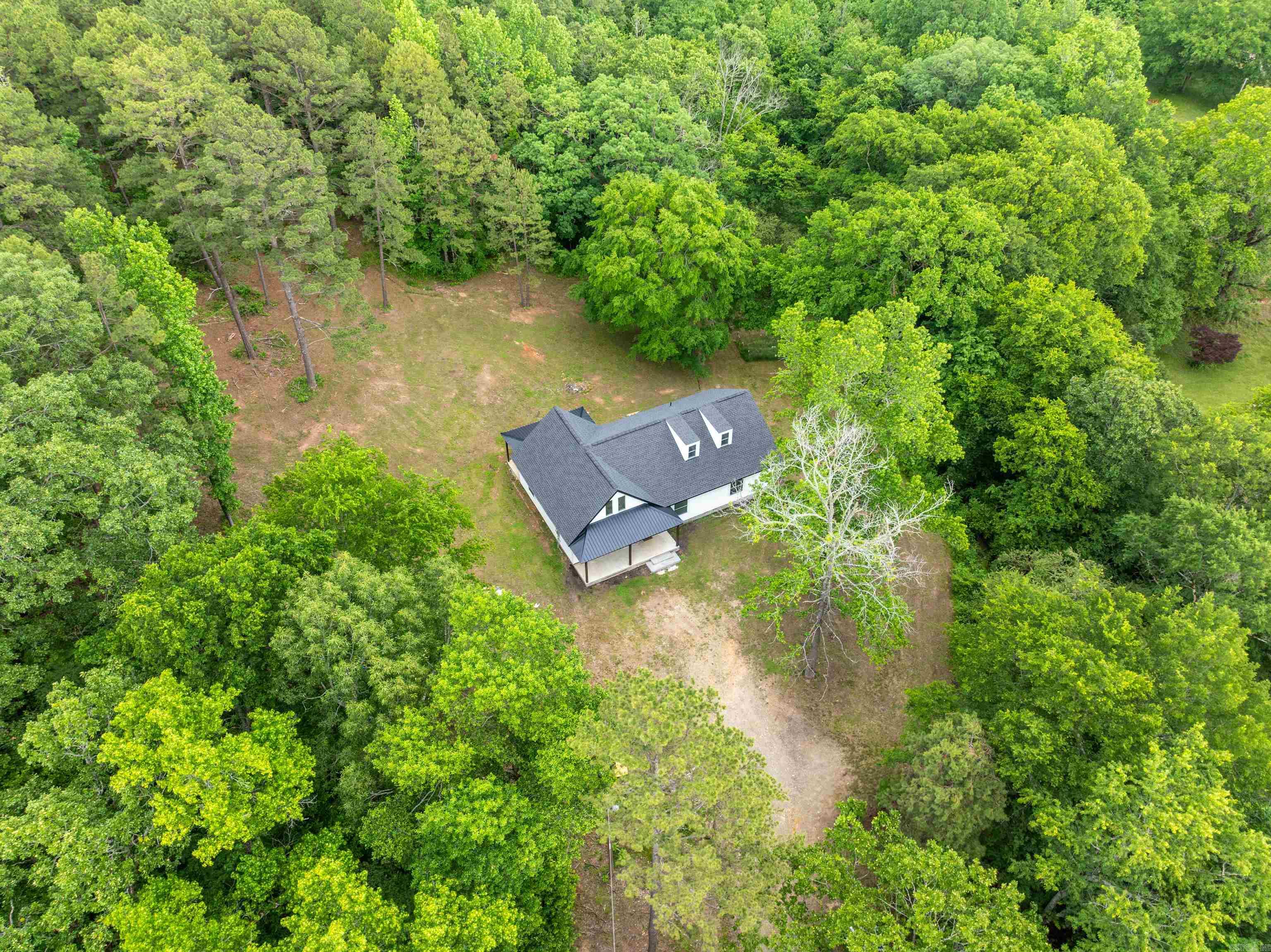 Stunning newly constructed home set on 4 spacious acres! Featuring all-electric and gas appliances, city water with the added option of well water. This spacious 2,400 sqft home offers 3 bedrooms and 2 bathrooms, with a large game room upstairs that includes an overlooking balcony. The modern farmhouse design boasts an open-concept floor plan, and it's move-in ready, with the option to purchase fully furnished! Approximately 1.5 acres of the property are cleared, while the remaining area is wooded, complete with a creek running along the right side. Schedule your showing today before it's gone!