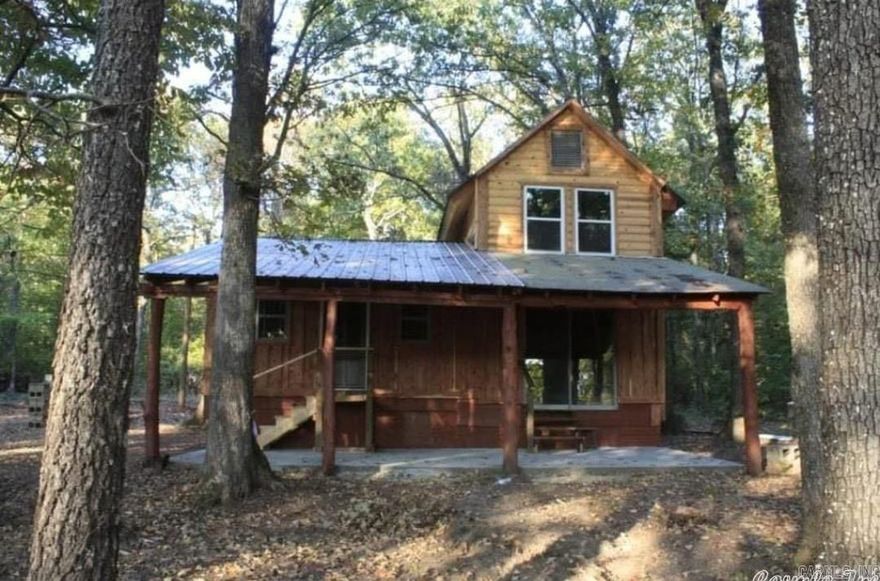 This 2 bedroom, 1.5 bath home has unique features like the tin ceilings, vintage doors, cast iron light fixtures, and laminated floors throughout.  The home has log siding and rough pine giving it a rustic feel.  It sits on 7.5 +/- acres just 2.4 miles from Marshall.