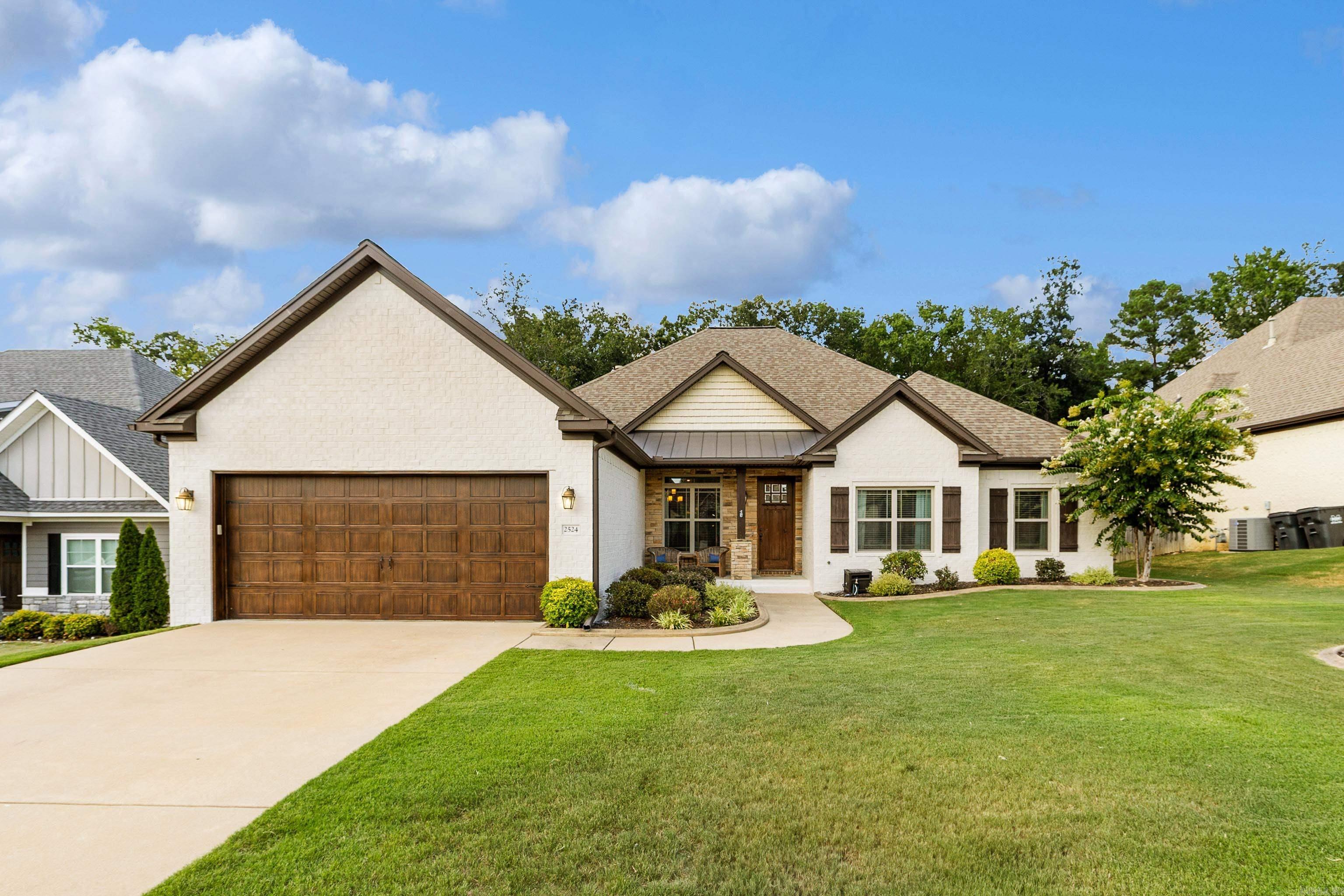 PRISTINE HOME IN THE HIGHLY SOUGHT AFTER HARPER'S LANDING NEIGHBORHOOD OF BRYANT! This stunning home features hardwood floors, soaring ceilings, and beautiful custom trim throughout. The chefās kitchen includes granite countertops, an island with gas range, spacious walk-in pantry, and wraparound bar seating that opens to a cozy hearth room with gas fireplace. A spacious living room and formal dining area make entertaining easy. The primary suite offers two vanities, two closets, and a custom tile shower, while the three guest bedrooms all include massive walk-in closets. Large laundry room with storage and mud area with bench and hooks. Situated on a large lot backing to private woods, the backyard features a covered porch, stained concrete patio perfect for a firepit, and a custom-built storage building on slab. Quiet, one-way-in, one-way-out neighborhood in the heart of Bryantādonāt miss this one!