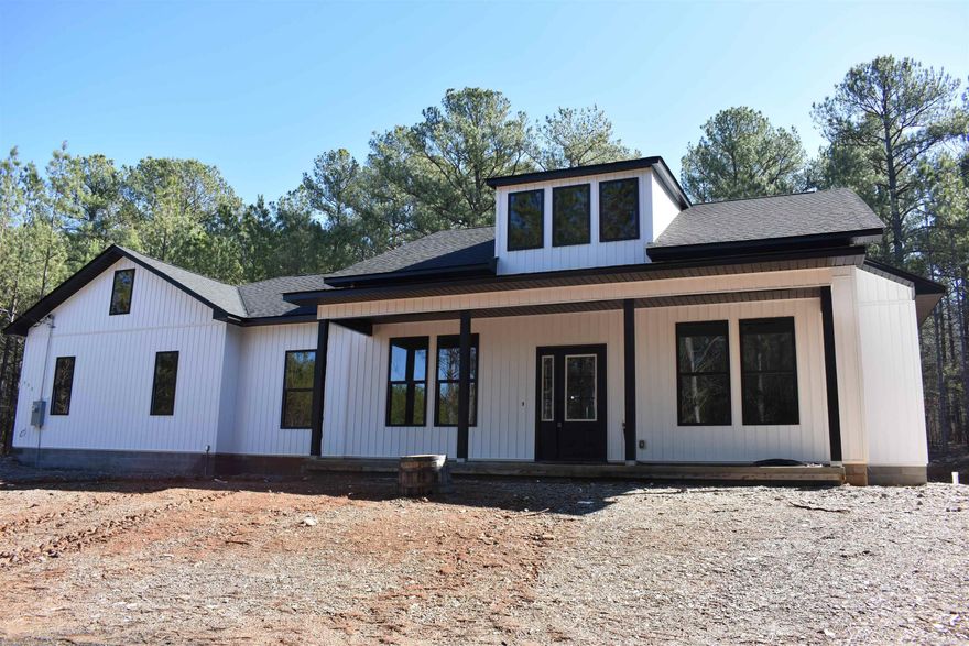 This is just what you have been looking for....acreage, privacy, FL Schools, paved roads and a brand new home.  No hoa fees and no water bill.  You have your own well and septic.  3 bedroom, 2 bath on one level with oversized garage that will hold your motorcycle, 4 wheeler or whatever toys you have.  No carpet in this home...all luxury vinyl.  Beautiful colors and finishes throughout including granite counter tops, custom cabinets, matt black hardware and custom front door.  The road is paved all the way to the property including driveway. There are other new homes (custom) under construction on Stihl Road.  You will love the setting where this home is located.  Hurry!  Don't miss out. Verizon has good service here.  AT&T does not.