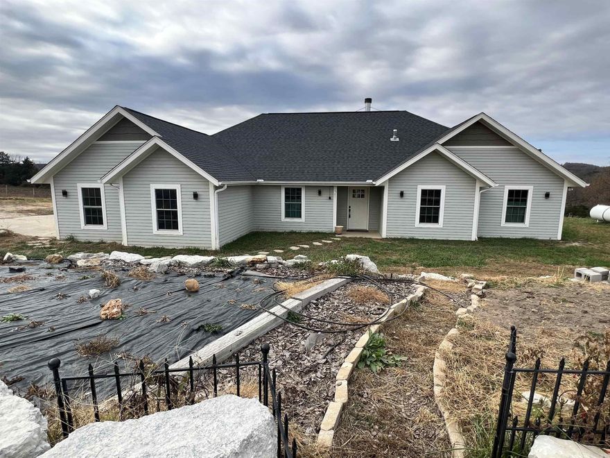Great Ozark Mountain homesteaders mini farm.  Come check out this 5 BR, 3.5 BA, 2,141 SQFT, 2 car garage, and 6.71 acres m/l.  The home features granite countertops, wood fireplace, wood stove location, walk-in closet, pantry, and much more.  The land is all in fenced pasture for livestock and has a 30’ x 40’ metal shop with concrete floor and electric.  Also, the land has apple trees, blueberry plants, medicinal herbs planted, and garden area.  Call today to schedule a showing.
