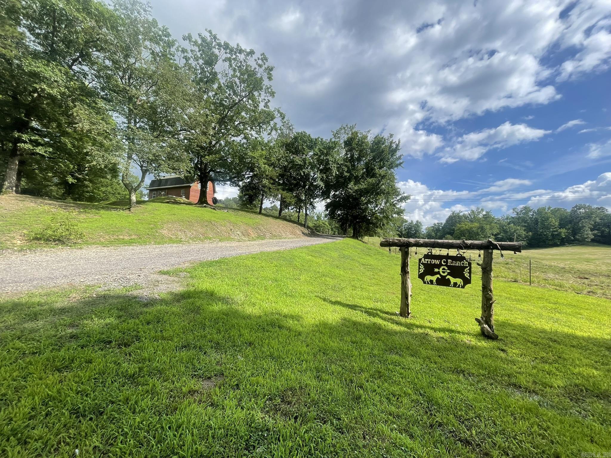 Seeking a turnkey cabin on approximately 10 acres, with picturesque pastureland, SERENE views, and a large pond? This amazing property has it all! This adorable cabin style home features an open floorplan, spacious kitchen with walk in pantry, 2- bedrooms, 1-bathroom, indoor laundry and a cozy loft. There are many outbuildings including a storm cellar, and a beautifully restored horse barn offering a place for entertaining, storage and plenty of space for your horses. The home operates on well water but is plumbed for city water. This gorgeous property is conveniently located in the Opal/Board Camp area close to Mill Creek, Wolf Pen Gap trail systems and other local trails. Making it a perfect place to establish an Airbnb with plenty of land to build more cabins or establish your own ranch.
