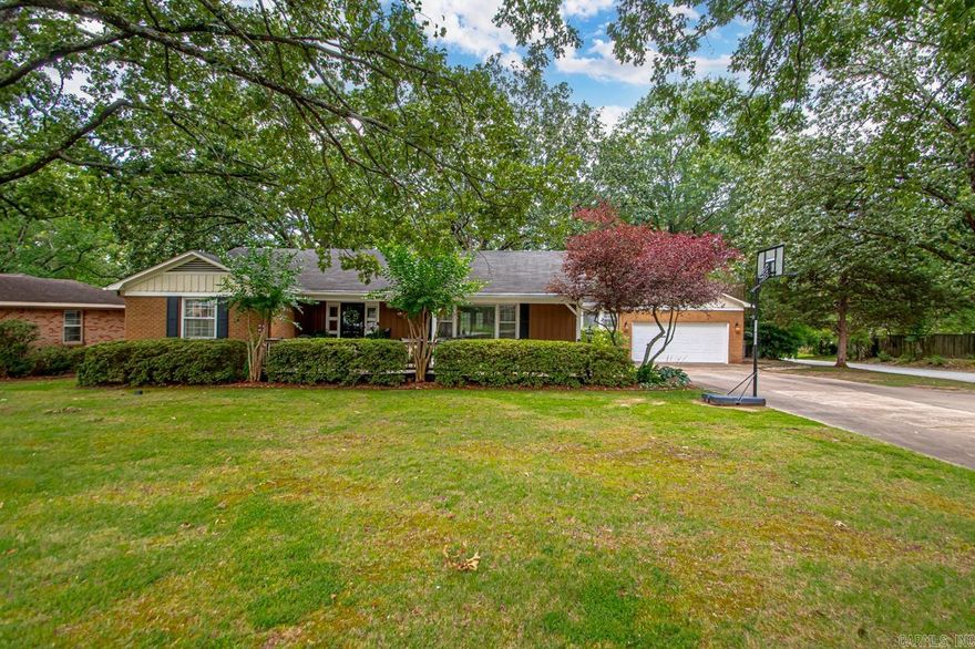 Welcome to this beautifully maintained 3-bedroom, 2-bath home situated on a generous ½-acre corner lot in the heart of Little Rock. Step inside to discover original hardwood floors in excellent condition, fresh interior paint, and an open-concept kitchen and living area perfect for modern living and entertaining. Enjoy the benefits of a tankless water heater, a 2-car garage, and a large back deck that overlooks a park-like backyard—ideal for gatherings or relaxing evenings outdoors. The lot is flat and spacious, offering both privacy and plenty of room to play, garden, or entertain. Conveniently located near shopping, dining, and amenities, this move-in-ready gem combines comfort, style, and a fantastic outdoor setting. Don’t miss your chance to own this rare find in a desirable location!