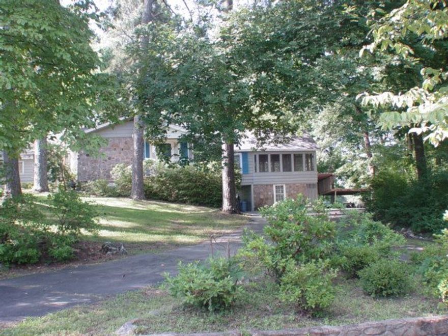 Beautiful lake views from this unique home on Lake Hamilton!  This home  boasts an open floor plan with 3 bedrooms and 2 baths. The large family room is perfect for entertaining.  A large screened in porch with original wood floors/ceiling is just off the master making summer nights even better on the lake!  This is a fully furnished listing.  Separate swim dock.  Boat slip has lift.  Includes 1 acre lot across from house on the street side.  Listed under $400,000 this is your chance to own on the lake!