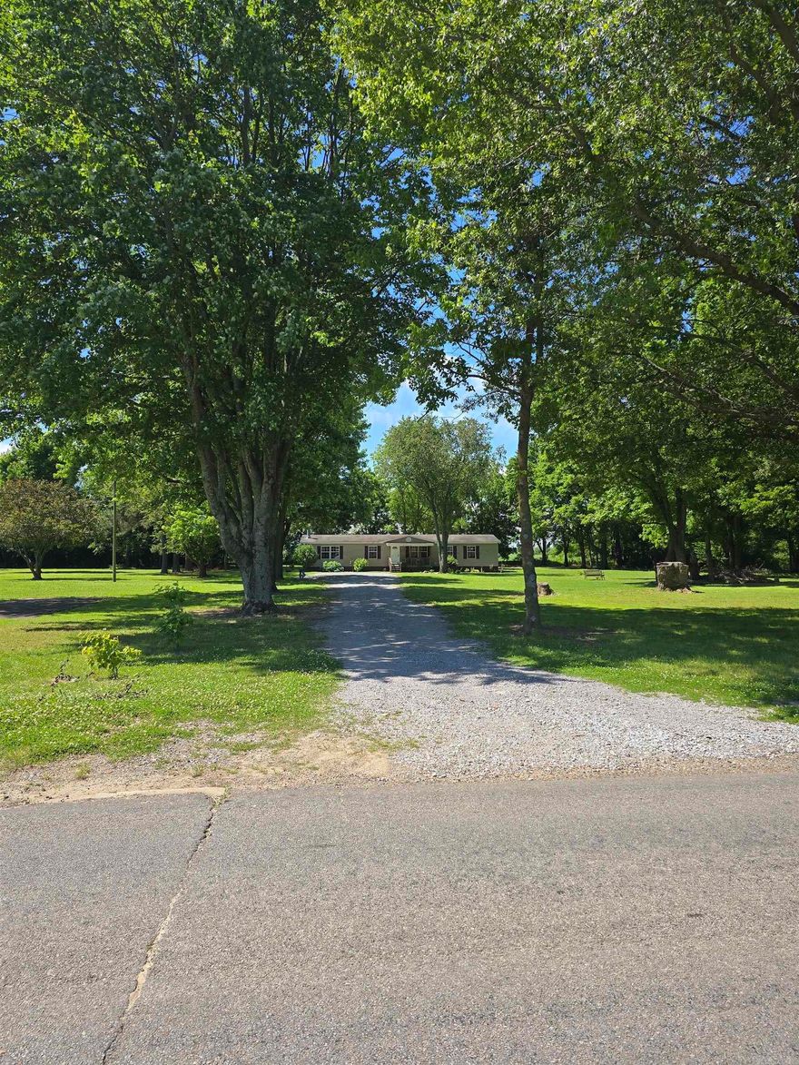Rare opportunity to own approx. 2 acres within the city limits!  3 Bedroom, 2 Bath Manufactured home sitting on approx 2 acres! Open floor plan with separate dining and eat-in kitchen with breakfast bar. Formal living room separate from great room. Cozy up by the wood burning fireplace for those chilly winter nights or enjoy sitting on the front or back decks to enjoy those warm summer nights. Plenty of room to roam on the 2 acres that possibly could be subdivided. Schedule your personal tour today!