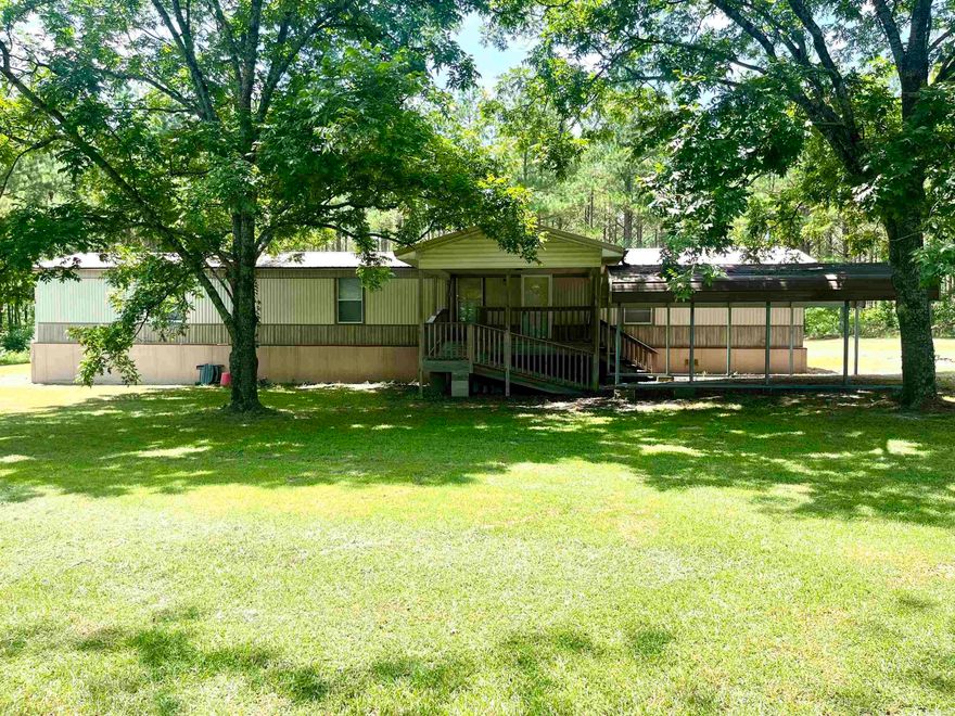 This property offers the perfect blend of comfort, convenience, and country charm. A cozy home on 3.27 acres, offering two bedrooms with walk-in closets and two large master-sized baths. Designed with an open floor plan, perfect for comfortable living and entertaining. Convenient all electric appliances, as well as being plumbed for Propane for an additional appliance or heater, if needed. A Large Covered Front Porch equipped with a ramp and steps for relaxing and enjoying the outdoors, with easy access for everyone. A single car carport and 20x10 outdoor shed and added covered storage for all your equipment and toys. This property is a great starter home with plenty of space to grow.