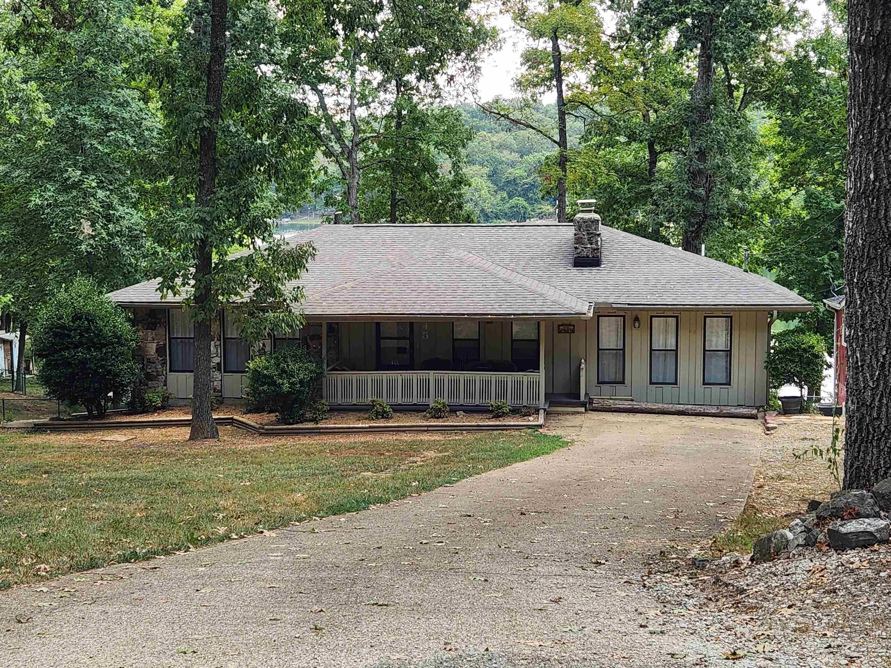 Outstanding Lakefront home on beautiful Lake Cheorkee. This 4 bedroom 3 bath home has been updated and refurbished. It is presently in the beginning stages of becoming a VRBO. Brand new roof, New paint inside and out, New floring throughout the home. The kitchen has all new appliances and counters. Primary bedroom is apart from the other bedrooms and has its own en-suite bath, dressing area, laundry, closet and access to the back deck. Wonderful lake views from the kitchen, dining area, even the back bedroom. The Partially covered back deck stretches the length of the house, offering plenty of entertainment area all with great views of the lake, the wonderfully landscaped yard and fire pit area. Nice dock for fishing and swimming. Lake Cherokee is known for its good bass fishing. Down stairs is a guest quarters with a full bath. It can be used for overflow company, mother in law suite or just as a private 4th bedroom. Book an appointment to see this one to really appreciate the beautful views and landscaping.