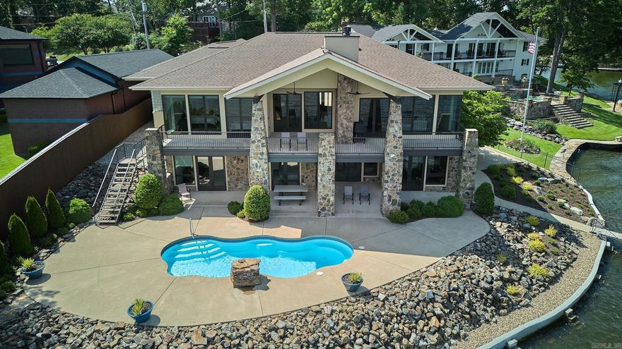 Welcome to your lakeside oasis! This stunning home, nestled on the shores of Lake Hamilton in Hot Springs, Arkansas, offers a lifestyle of elegance and comfort. Let's explore the features that make this property truly exceptional: **Lake Views**: Imagine waking up to breathtaking sunrises over the tranquil waters of Lake Hamilton. These views will captivate you whether you're sipping your morning coffee or hosting guests. **Outdoor Paradise**: Relax in the saltwater pool or unwind on one of the two covered patios. The outdoor living spaces are perfect for entertaining or simply enjoying the serenity of lakeside living. **Double Boat Dock with PWC Lift**: Boating enthusiasts, rejoice! With a double boat dock and a personal watercraft (PWC) lift, you have ample space to moor your watercraft. Spend weekends cruising the lake, fishing, or simply basking in the sun. **Spacious Interiors**: This 5-bedroom, 4.5-bathroom home spans 4,598 square feet. Soaring ceilings create an airy ambiance, while large Marvin windows and doors flood the interiors with natural light. **Primary Suite Retreat**: Wake up to lake vistas in the primary suite and unwind in the spa-like bathroom and large shower.