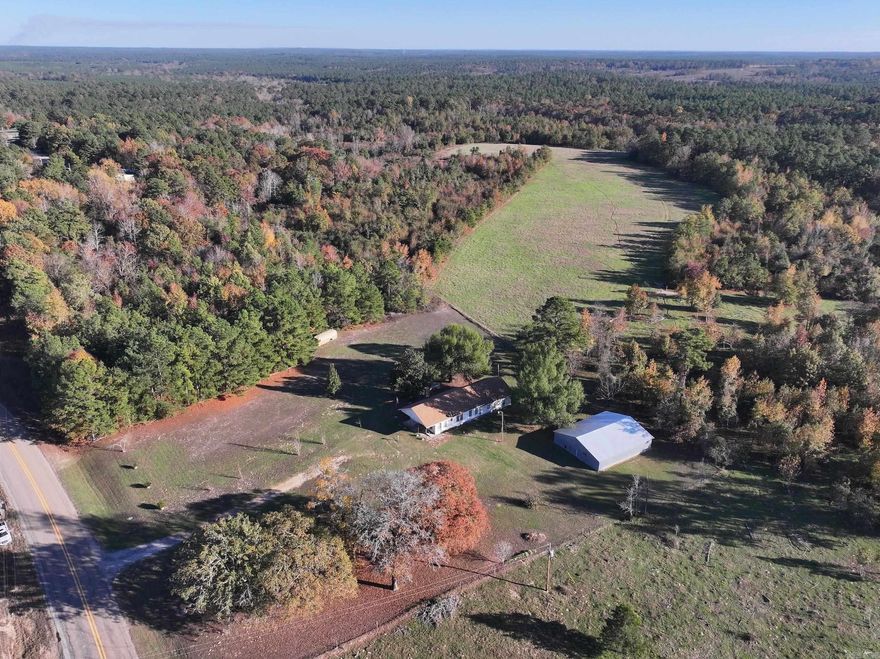 Here is your opportunity to own an almost 80 acres of exceptional acreage that had been in long time ownership.  Beautiful , partially cleared acreage that has had many uses over the years.   Row crops, livestock grazing, and hunting to name a few.  Wildlife is abundant and the almost 80 acres of partially timbered land, adjoining a tree farm area, are a dream situation if you are a deer hunter.  Lease for grazing or run your own herd.  The generous sized, well built barn in good condition has sturdy hay loft & new roofing added in '21. The comfortable home is pleasantly located well away from highway noise & has plenty of parking space in front   Access at front door is ramped for easy accessibility.  Inside has a very large living/dining room, 4 rooms with closets plus 2 additional bonus rooms, 2 full baths & separate laundry room.  The very generous sized back room was specifically designed to accommodate long-arm quilting machine setup & would make a great business space since it has it's own entrance.