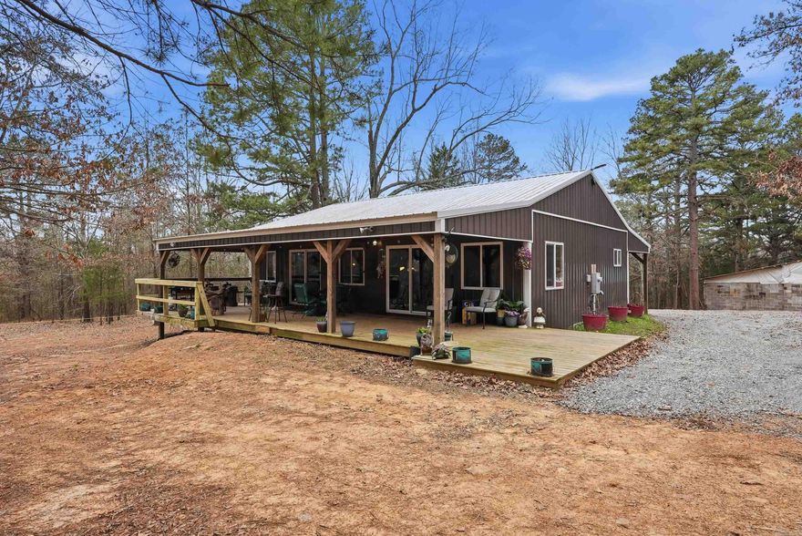 1.70 acres walking distance to the public boat!  Just built in 2020.  Option to buy extra corner lot for $25,000 (lot not for sale unless with the house). Looking for a cabin feel , this home has some cool unique features , hand built Kitchen Island on antique wheels,1954 antique oven works great , hand cut cedar countertops, Bluetooth speakers in bathroom lights , large covered back porch , on well water ( city water available at road) , Block Garage for extra covered storage space.