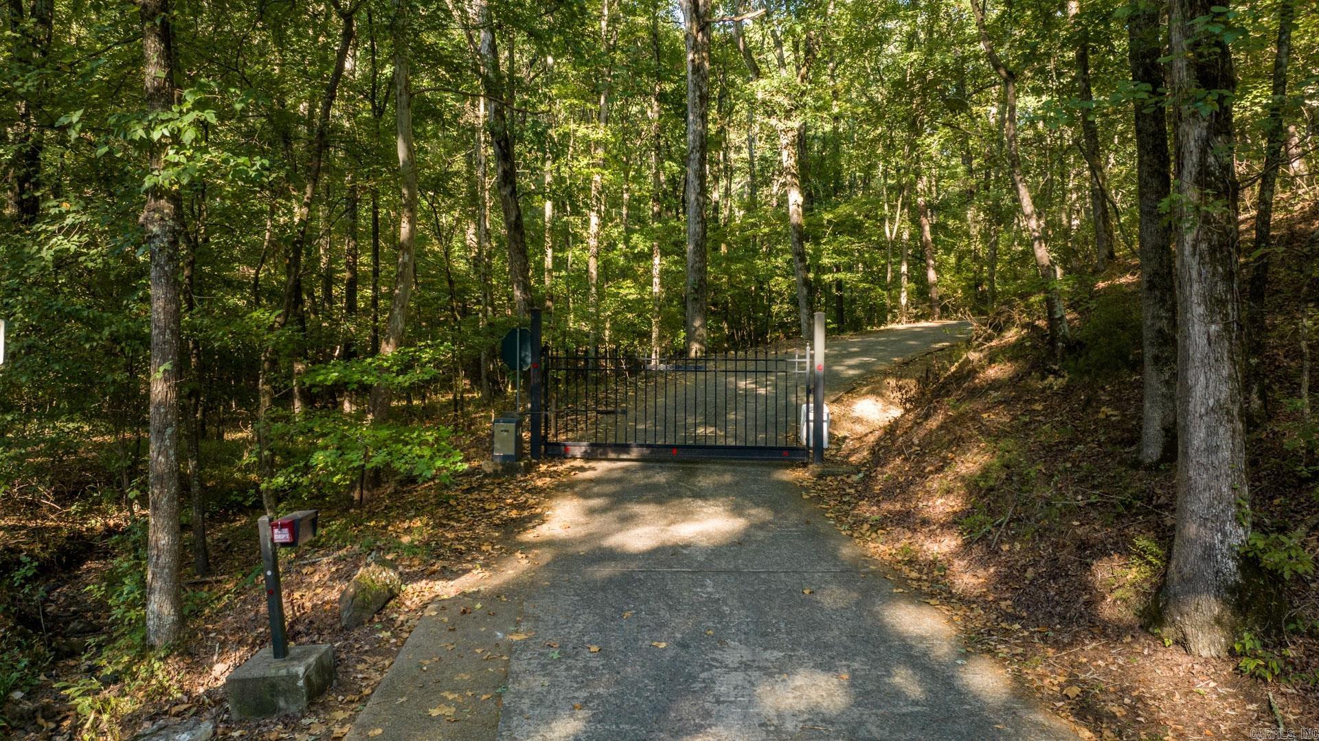 5-acre residential lot with shared gate access on Foxridge Road. Located minutes from the shopping, restaurants, entertainment and highly rated schools of West Little Rock, this acreage features mature trees, a wet weather creek, gentle slopes and potentially two building locations. Previously approved for septic. AGENTS READ REMARKS FOR INQUIRIES *Gate code needed for access.