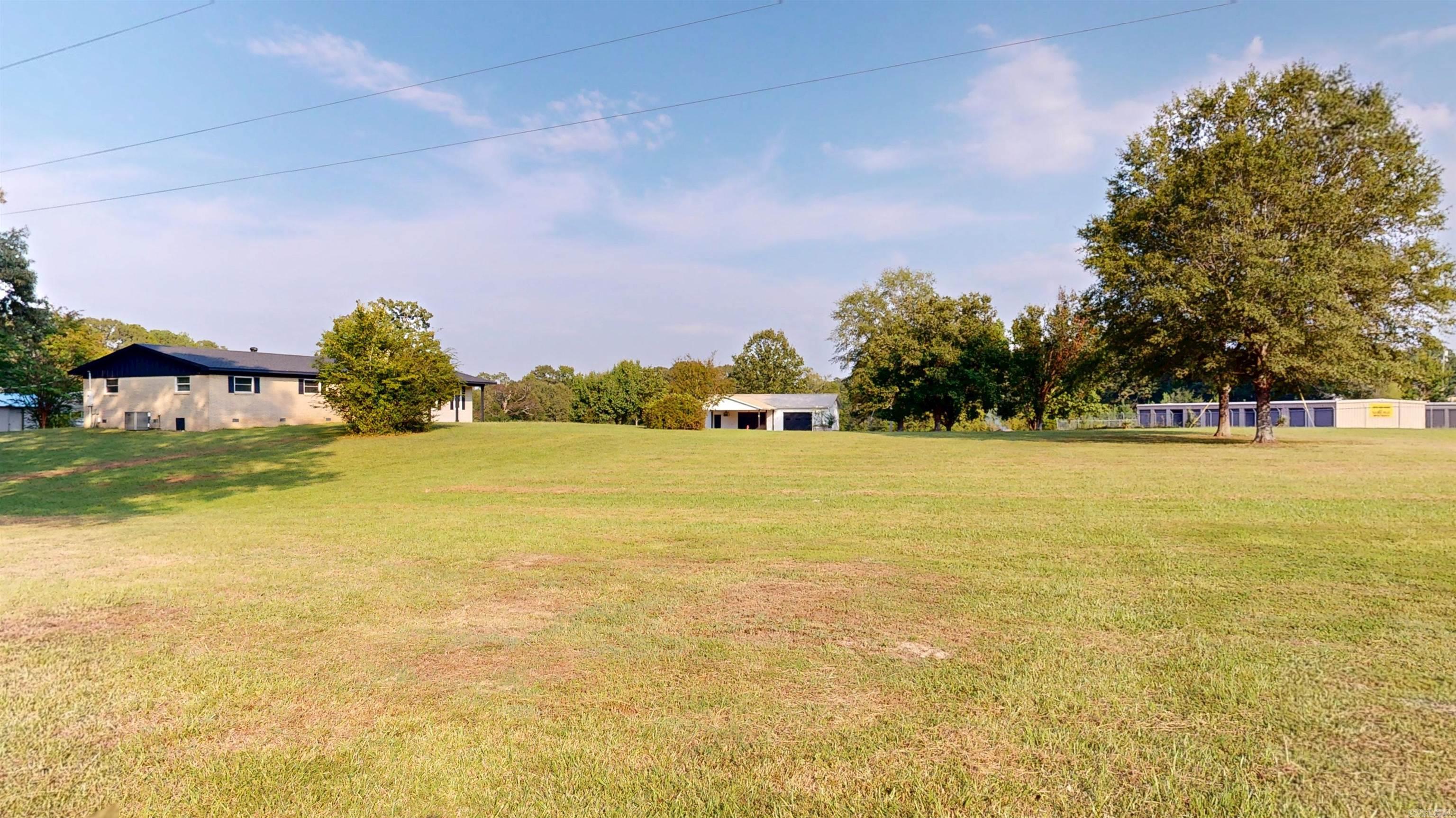 THIS GEM IS A RARE FIND! It would be an awsome multi-generation family homestaed with an income or a perfect Investment property with 2 large homes, massive shop, and 50 storage units, currently at 95% occupency, Hwy 7 frontage, on 17.94 +\- acres, in addition there's a concrete pad with a seperate address to accommodate a large RV or small mobile home. will cash flow from day one with lots of room to expand. It's minutes from beautiful DeGray Lake! This property includes: (1) an HGTV ready custom manufactured home on concrete footers, built in 2023, with 2137 sq ft, 3 bedrooms, 2.5 bath, extra large master suite with an incredible en-suit bath, huge custom walk-in closet, laundry room, mud room, coffee bar, covered front porch and rear patios, direct wired Generac generator and a massive 2 car garage. (2) A Brick home with open floor plan, custom kitchen cabinets, updated appliances, 2 full baths, and large hallway. This home feels much larger than 1600 sq ft! It also includes a large laundry room/storage room, covered rear patio with an outside counter and sink and a 2 car garage. It has been freshly painted inside and out, with upgraded electrical wiring, new roof in June 20