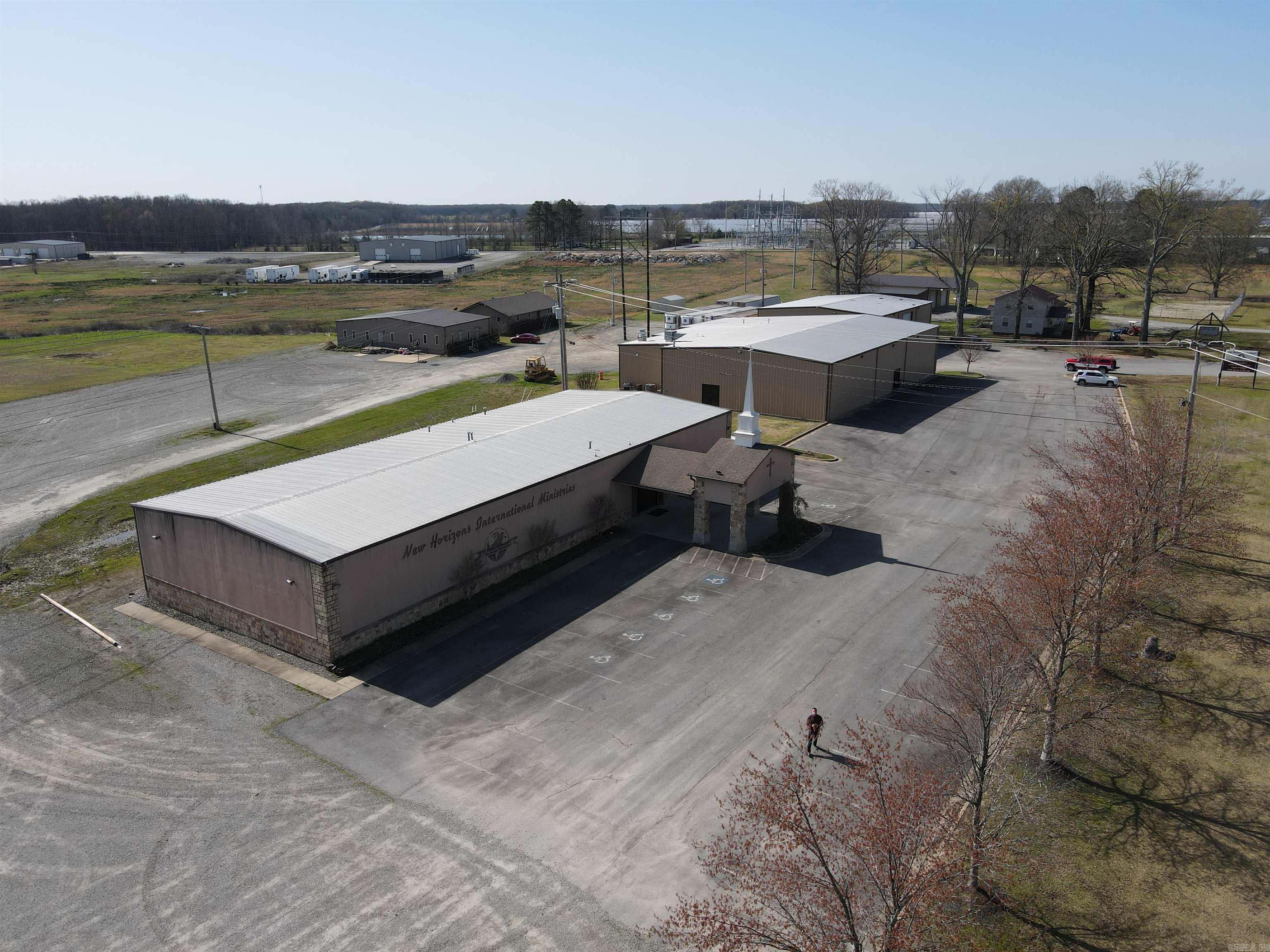 Nestled just outside the vibrant city of Searcy, Arkansas, this expansive church campus offers a serene 9.32-acre retreat with five buildings totaling 25,898 sq ft. Strategically positioned near essential amenities like Walmart and Lowe's, Searcy, the heart of White County, is a dynamic blend of community spirit and economic growth. The church complex itself is meticulously maintained, featuring a 7,150 sq ft main church with a full suite of facilities including a sanctuary, nursery, youth church, and classrooms. The 9,690 sq ft fellowship hall boasts a restaurant-grade kitchen and spacious open halls. The property also includes a heated 4,697 sq ft food bank, a comfortable 3/2 single-family house, and a multi-family building with 11 bedrooms, all in excellent condition. THIS PROPERTY CAN BE SPLIT UP PLEASE HAVE YOUR AGENT INQUIRE FOR MORE INFORMATION.