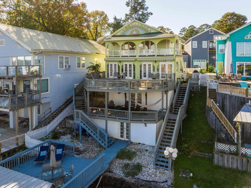 Location, location, location!!! This 3bd/3ba historic main channel lake home is available for nightly rentals or personal enjoyment.  Use it for personal fun or rent it out for additional income. Easy access to town but just a stones throw from the city limits make it the ideal vacation rental property.  No extra permits required!  Enjoy one of the 4 decks overlooking Lake Hamilton and bask in the views.  The covered boat dock has water access even during the winter. Kitchen has new appliances and granite countertops. Upstairs has original hardwood floors refinished to their original glory. There is an extra kitchen outdoors for all your entertaining needs. Each deck is appointed with outdoor furniture for maximum enjoyment. Carport plus a dedicated parking spot is assigned to this house, and the neighborhood has a pool for an extra perk.