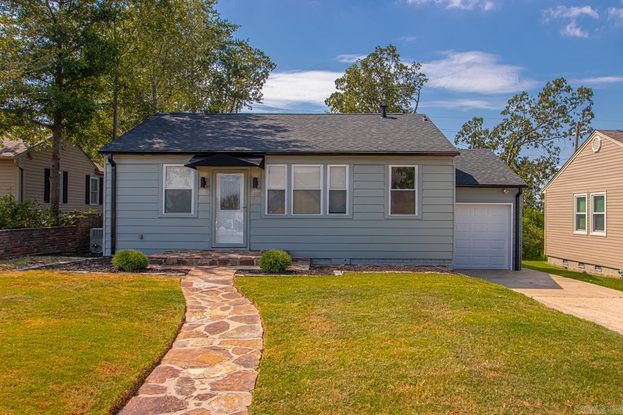 Freshly renovated with curb appeal to match! This Little Rock home features hardwood floors, an open kitchen, living, and dining layout, and freshly painted exterior. The kitchen offers solid cabinetry, updated countertops, and stainless-steel appliances. Bathrooms have been remodeled with modern tile and fixtures. A one-car garage, flat lot, and spacious backyard provide plenty of room for storage, entertaining, or outdoor living. Roof is less than two years old for peace of mind. Located just minutes from downtown, top-rated schools, and less than a block from Baker Park, this home blends thoughtful updates with a convenient location.