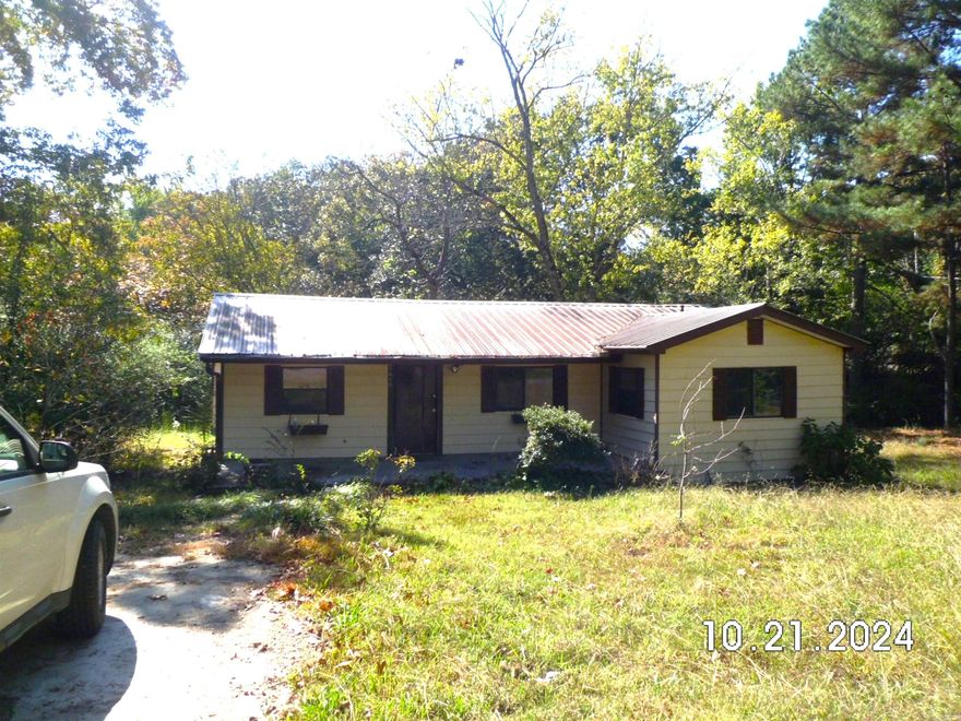 Perfect opportunity for anyone looking for a fixer upper!! This cute home sitting on 2 city lots, unfortunately, had an electrical fire that damaged the ceiling in the front two rooms. The tankless hot water heater and gas free-standing stove still work. There is a very nice large deck on the back of house and a storage building for your extra stuff. Before the fire, new laminate flooring had been installed. There are two bedrooms, one bathroom, and an extra room that could be 3rd bedroom. This property will be sold "AS IS".
