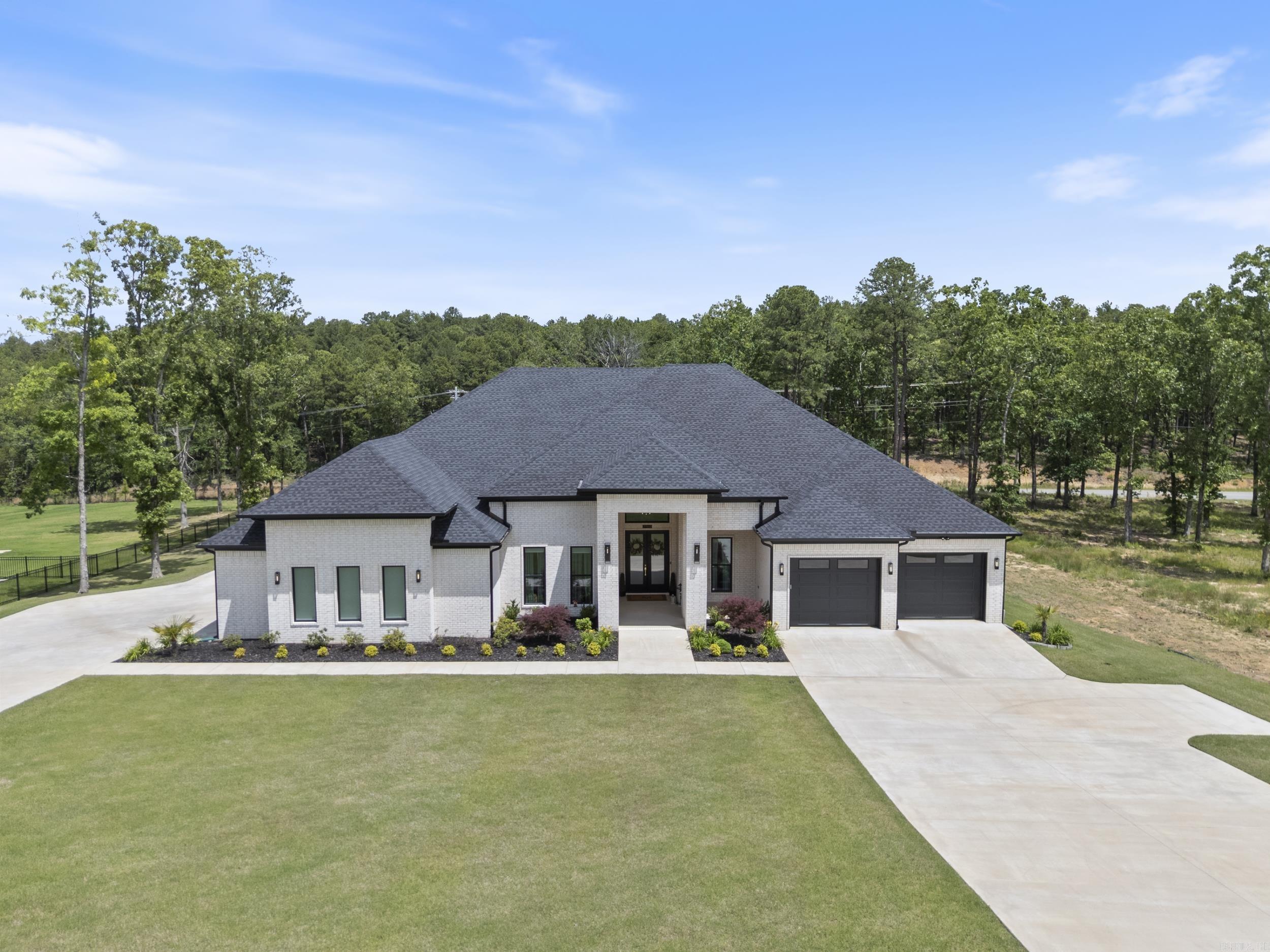 STUNNING contemporary 3,955 sqft custom-built home sits on a meticulously landscaped 0.89-acre lot in Orchard Hill Sub equipped with sprinkler system! Designed with high-end finishes and functionality in mind! Features 4 bedrooms, 3 full bathrooms and flowing open-floor concept layout. The heart of the home is a chef’s kitchen with premium appliances, large island, and custom cabinetry that opens to a generous living area and formal dining space. Enjoy the wet bar with mini fridge leading into a large walk-in pantry. Primary suite boasts a sitting area, luxurious en suite with vanity, large dual shower and massive closet. A dedicated bonus room/media room includes built in desks perfect for a study/gaming center and connected to a separate flex space separated by a pocket door for privacy. Amazing screened-in back porch area complete with a gas fireplace and a full outdoor kitchen. Salt water heated POOL with diving wall and spiral slide. Rare 4-car garage, ample storage throughout, and refined design choices at every turn. This home delivers everything you could want! Location offers privacy and spacious lots in a country setting with Conway Corp utilities!