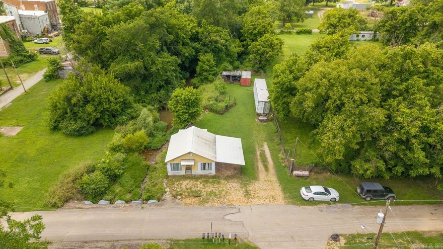 Discover the peaceful charm of this 1-bedroom, 1-bath retreat nestled on approximately 0.5+/- acres in the heart of Mammoth Spring, Arkansas. A year-round creek runs through the property, creating a serene natural setting right outside your door. The cozy home features a functional layout with rustic appeal—perfect for a personal getaway, full-time residence, or short-term rental with a little TLC. Outside, enjoy mature trees, a fenced garden bed, and open yard space ideal for relaxing or growing your own vegetables. Additional features include a shed and two large enclosed trailers for storage or hobbies. Located in the scenic Ozarks, this property offers privacy, nature, and endless potential. Whether you're seeking investment opportunity or a quiet escape, this creekfront gem delivers the best of both worlds. Don’t miss your chance to own a slice of the Ozarks—schedule your showing today!
