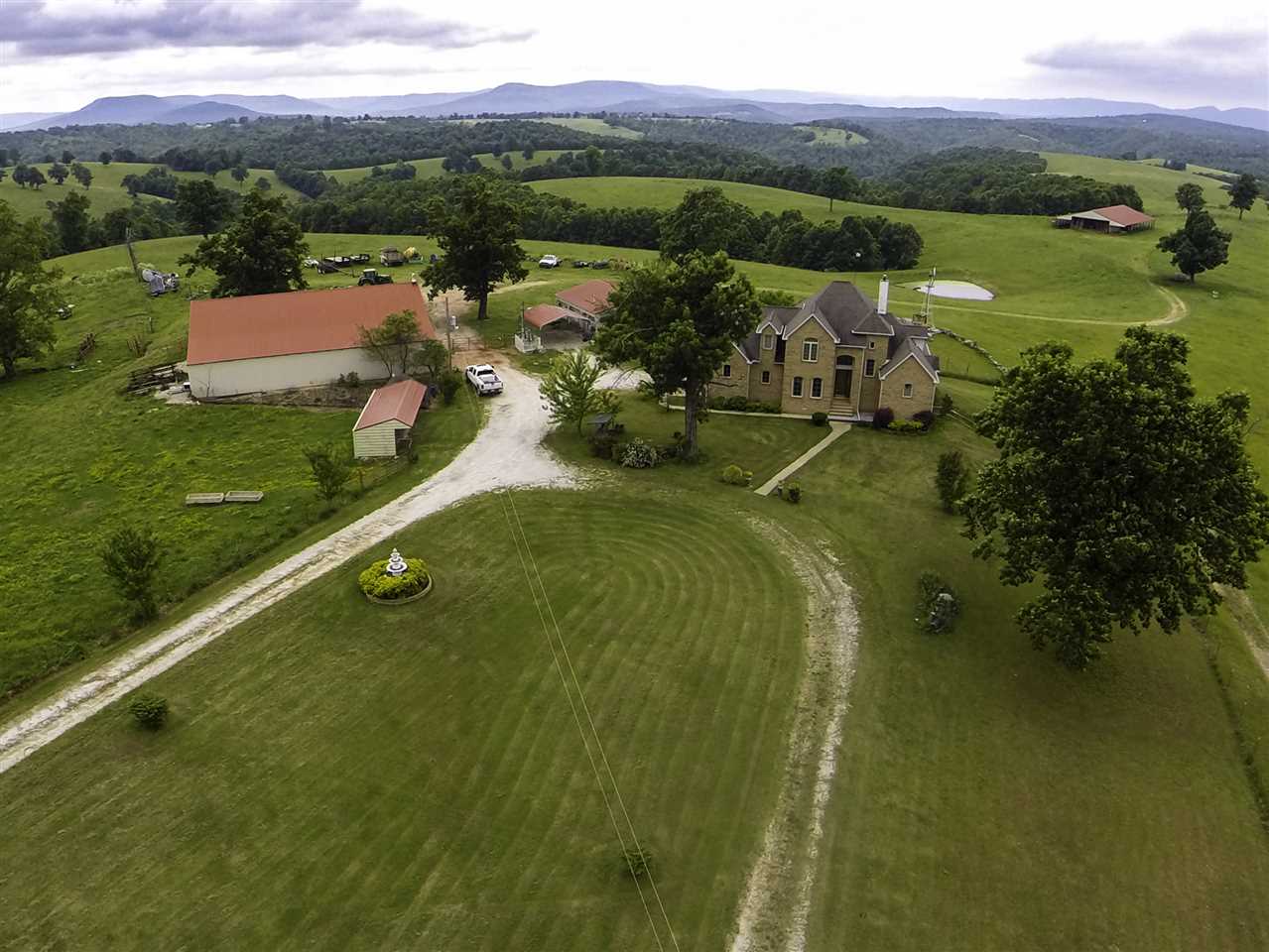 1,790 ACRE RANCH!! Luxurious 2 story, 2,945 sqft. brick home. Year-round creeks & springs, waterfalls, caves & 15 ponds. 75x40 insulated shop, two auto sheds, ATV shed, 40x100 hay barn, plus additional outbuildings. 500+ acres lush pasture, fenced and cross fenced with five sets of corrals. Set up for a hunting & recreational business including two new guest cabins, meat processing locker & walk-in freezer, very nice hunting blinds & regular deer stands. Wildlife all over!! Close to the Buffalo River.