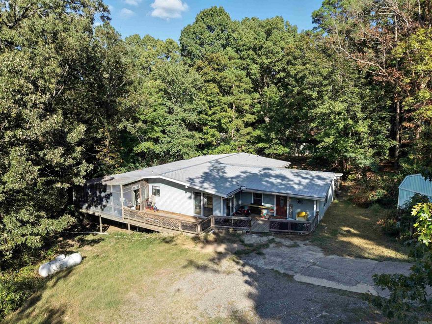 Nestled on a hill in the heart of Heber Springs, this beautifully updated home offers the perfect blend of comfort, privacy, and natural beauty. Surrounded by mature trees, the property provides a serene escape while still being just minutes from town and the lake.  Step onto the expansive wraparound porch and take in the peaceful views — the ideal spot to enjoy your morning coffee or unwind at sunset. Inside, you’ll find thoughtful updates throughout, including modern finishes that complement the home’s warm, inviting feel. Every detail has been designed for both style and functionality, making this home move-in ready and full of charm.  Whether you’re looking for a weekend getaway or a year-round retreat, this Heber Springs gem is one you don’t want to miss! See remarks.