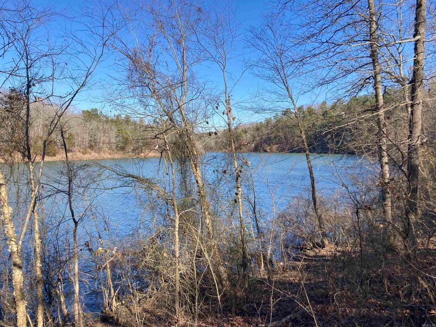 Beautiful Barnett Lake lakefront lot for sale. Over 1 acre with great views and gentle slope to the water's edge. Building site is out of floodplain. No mobile homes, 1,400 sq ft minimum build. Great area, wonderful sunsets and incredible fishing all year long for bass, crappie, catfish, and bluegill. Geese and ducks frequent the lake each fall/winter and you will be able to hear turkeys gobbling nearby in the spring. Paved road access in a very safe area. Located next to public boat ramp.