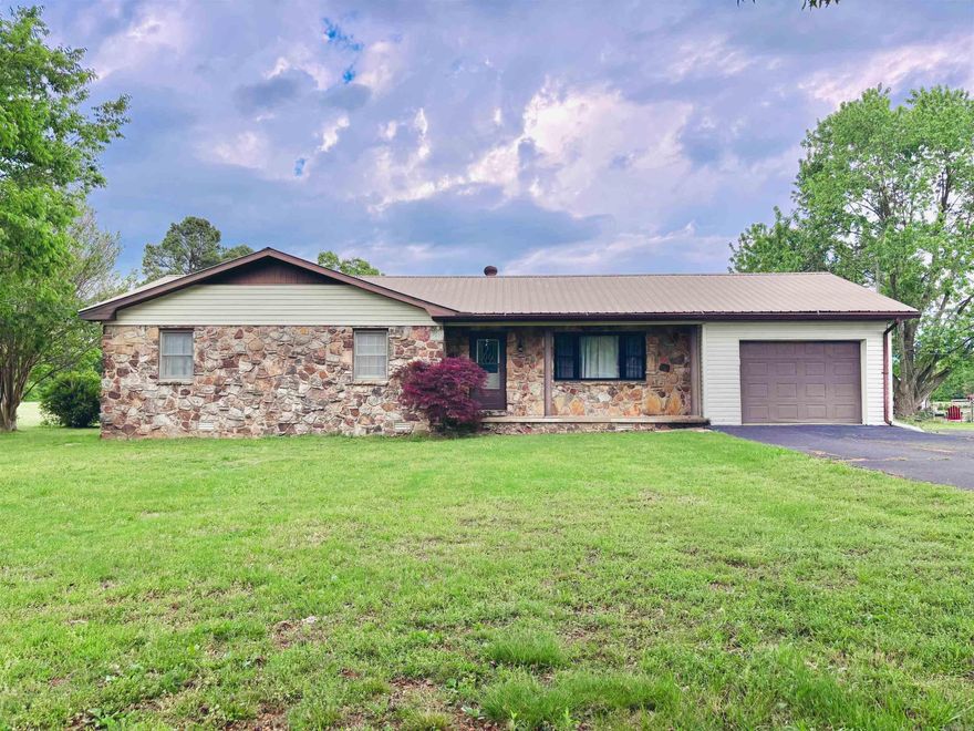 Tucked away on just under an acre in the rolling hills of Pocahontas, this 1,808 sq ft home offers the best of both worlds—just minutes from town, yet far enough out to feel private and peaceful. From the moment you arrive, the covered front porch invites you to slow down and enjoy the quiet. Inside, the home is warm and functional, featuring central heat and air, a laundry room, and an extra room that easily becomes a dining space, home office, or cozy retreat. The metal roof adds durability, while the 1-car garage provides everyday convenience. Out back, a covered deck overlooks the property, perfect for morning coffee or evening sunsets. For those who need space to work or create, two shops—an 8x12 and a large 20x40—offer endless possibilities. This is country living with comfort, space, and the ease of being close to everything Pocahontas has to offer!!