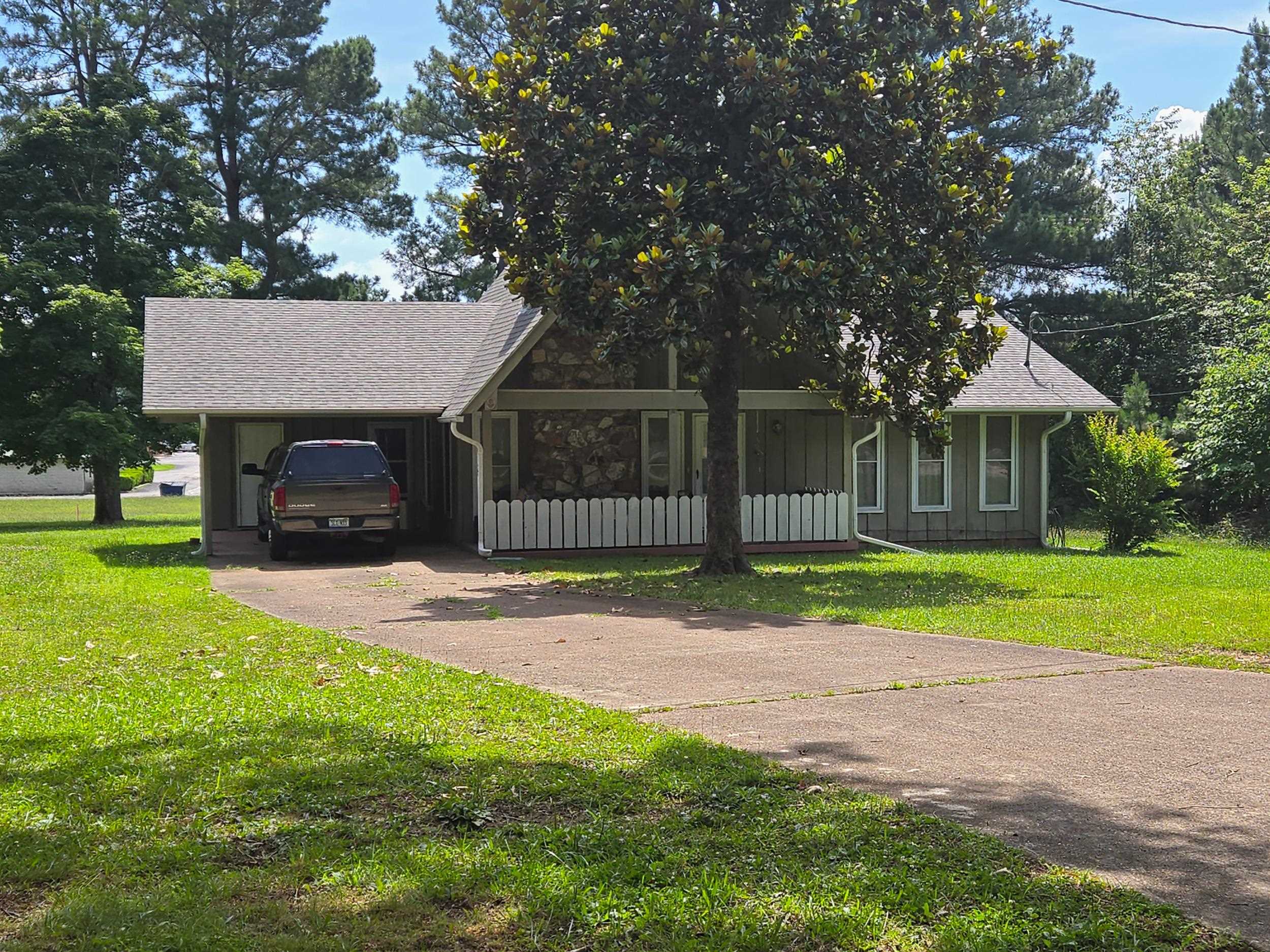 SOUTH ENTRANCE NEIGHBORHOOD - Walking distance to the South Entrance and Hwy 62/412, 2 bedrooms, 1 3/4 baths, vaulted ceiling in the open living room/dining/kitchen, sun room on the back and laundry room with door that opens to chain link fenced pet yard. Native stone wood burning fireplace with insert, plumbed for dishwasher and water softener. 32x50 three-car garage wired for 220 amps, one of bay doors RV height. Level lots with good shade trees. Stove and refrigerator, washer and dryer included in sale of home.