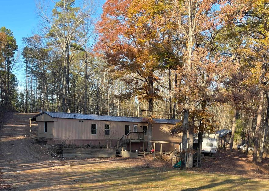 Fantastic land, almost 4 acres, remodeled mobile home with metal roof. Own the end of the road! Bordered on south by over 600 timber acres!