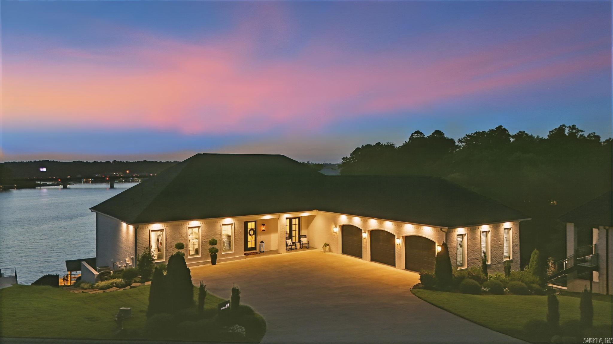 Enjoy stunning views from your new custom built home located on the main channel of Lake Hamilton. Located in a gated community on a private cul-de-sac, this home features 100 feet of lakefront with a seawall. The private 2 slip boat dock is equipped with two 7500 lb lifts. Inside you will find 10 ft ceilings on the entry level and 9 ft ceilings on the lower level with 3 step crown molding. You will love the hardwoods throughout with tile in the bathrooms and carpet in the closets for your comfort. Bedrooms have ensuite baths and walk in closets with custom built ins. There is a living area on both floors as well as nugget ice makers on each floor. The kitchen has 2 dishwashers and a large pantry. For added convenience you will find 2 offices, gym, safe room, gift wrap closet and plenty of large storage closets. The 3 car garage has a shop and an additional laundry room. The home includes a security camera system, surround sound inside and out, dehumidifier system, electric shades, built in grill/cooktop, 2 gas log fireplaces, 3 AC units and 2 tankless water heaters. The grounds are beautifully landscaped with a sprinkler system and iron fencing. This is luxury!