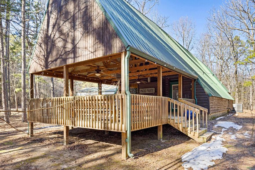 Tucked away on 4 wooded acres atop Petit Jean Mountain—less than 2 minutes from Petit Jean State Park—this A-frame cabin, Moosehead Cabin, feels like an escape the moment you arrive. Designed for quiet mornings and late nights, the home features an extended covered front porch that’s perfect for hosting friends or simply unwinding while listening to the whippoorwills roll in at dusk. As the sun sets, soft pathway lighting guides you from the fire pit back to the porch, creating a warm, inviting atmosphere for evenings you won’t want to end. Inside, you’ll find over 1,600 sq ft of comfortable, welcoming space. A gas fireplace anchors the living area, with the signature moose above it adding character and charm. Two spacious bedrooms and an oversized loft provide plenty of room for family, guests, or a relaxing weekend retreat. A large shop offers additional space for projects or storage. This isn’t just a house—it’s a place to slow down, spread out, and enjoy life near one of Arkansas’ most iconic destinations.