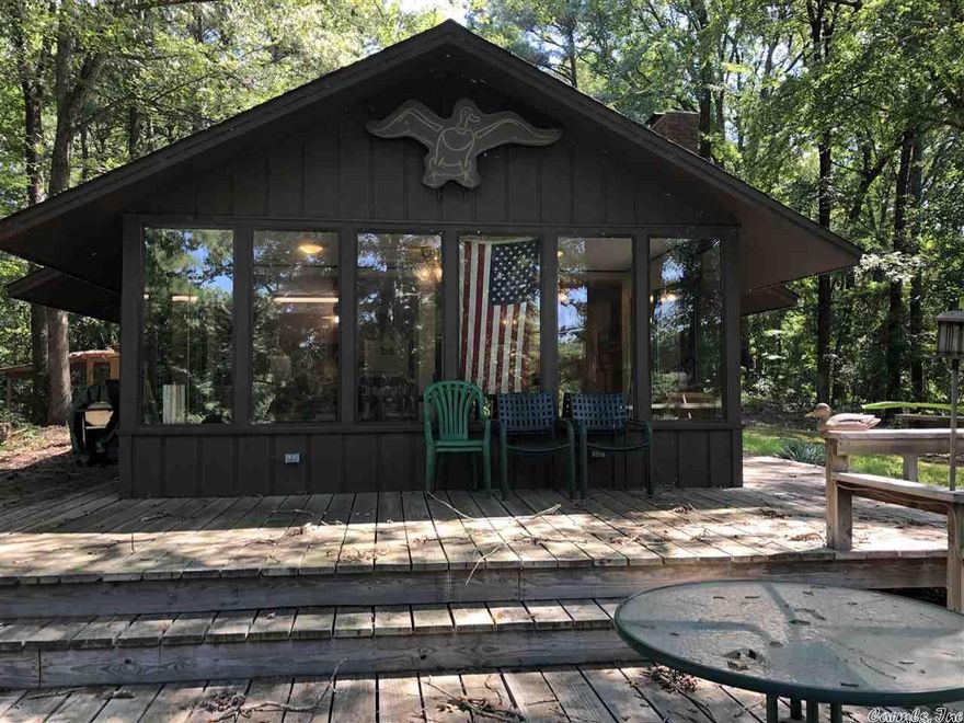 Purchase of this property includes 1 SHARE of the famous Holly Mound Duck Hunting Club.This membership gives you rights to the clubhouse, ALL duck hunting.  You can bring guest.  The cabin is deeded and sets on .94 acres, with your own dock with two boat slips.  Unlimited fishing and unlimited guest.  You can live at the Cabin year-round.  There is a $7,500 yearly Dues to the duck hunting club.  This money pays for a full time Manager that keeps up with ALL the hunting areas.  The share can be sold.
