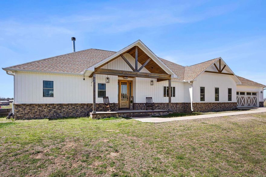 Welcome to the perfect blend of modern elegance and country charm! Cathedral ceilings and expansive sliding doors flood the home with natural light, creating an inviting atmosphere. The open-concept layout features a stylish kitchen with a custom vent hood, ample cabinetry, and a spacious island. A split floor plan offers privacy, while the spa-like primary suite boasts elegant fixtures and a luxurious walk-in closet. Smart upgrades like iotty motion-sensor lighting throughout and a fingerprint scanner in the main bedroom enhance convenience and safety, and solar panels power both the home and shop, ensuring efficiency! Outside, a fully fenced pasture is ideal for livestock, while a 40x80 electric shop with an insulated workspace, full bath and garage door offers endless potential.