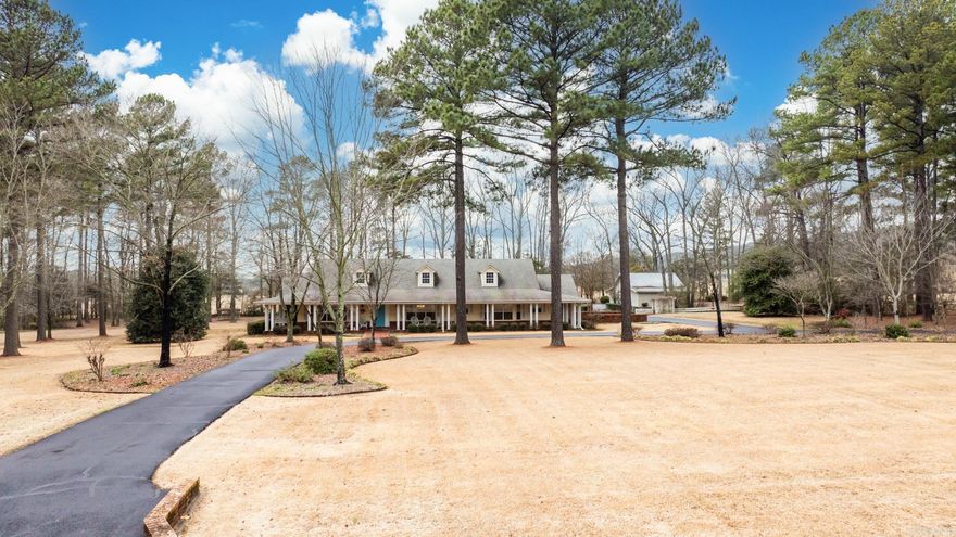 Gorgeous setting in an established neighborhood close to schools and shopping. ThThis rare find includes secluded setting with a huge wrap around porch. Storm shelter in garage and a huge shop of every mans dream with three separate areas This is a MUST SEE