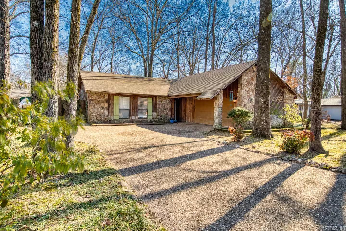 Charming 3-bedroom, 2-bath home surrounded by mature trees and timeless character. Inside, you’ll find a warm and inviting living space featuring a striking wood beam ceiling and a cozy wood-burning fireplace. The kitchen is updated with sleek stainless steel appliances, blending modern convenience with classic style. Enjoy the natural light in your sunroom overlooking the backyard. Spacious bedrooms and thoughtful details throughout, this home offers comfort and charm in every corner. ***Agents see remarks for showing instructions.