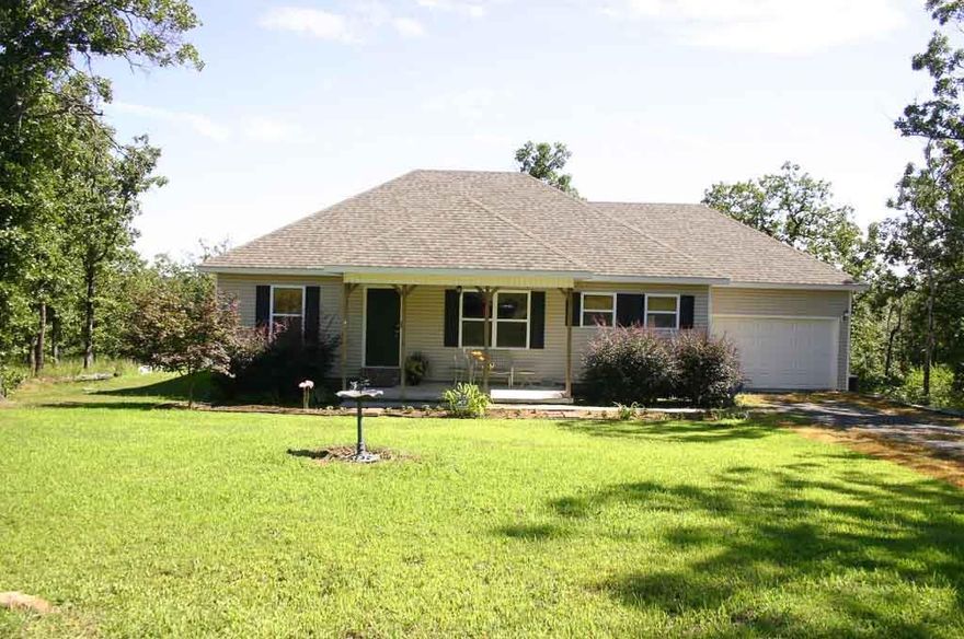 This is an amazing home in a quiet country setting on a private acre of land. It has a covered front and back porch perfect for enjoying the wilderness. This 3 bedroom 2 bath has an open floor plan. The kitchen has beautiful tile floors, stainless steal appliances, and window seat for extra storage and seating. Home has an above ground storm cellar. This home was built energy efficient. Call me today for more information and to view a showing. Also, an additional .94 acres available if looking for more land