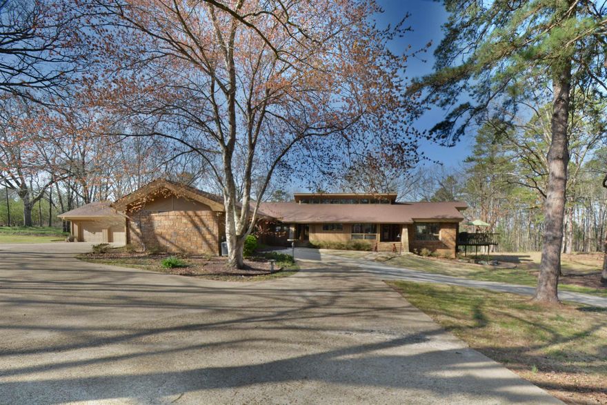 This stunning, custom-built one-level home is an absolute must-see. Two minutes from the prestigious Lakeside Schools, it boasts 4916 sq ft (including the pool house) and sits on 3.4 beautiful park-like acres.Nestled in a small neighborhood that provides privacy but convenience for shopping, this home offers four bedrooms, including two primary suites with adjoining private baths.  Adjacent to the primary bedrooms, you’ll find an exceptional closet system, a walk-in closet, and a laundry room. At the other end of the home are two bedrooms, each with an ensuite bath. The house has two rock fireplaces, vaulted ceilings, hardwood, flagstone, and tile flooring, and a gourmet kitchen with stainless steel appliances and granite countertops. Pella windows and doors open to a large deck for entertaining and wildlife viewing. There are two large flex rooms, an oversized 3-cargarage, and extra parking pads. An enclosed breezeway with a storage area off the garage leads to a dog run for your pet.  An 18 x 36 in-ground pool is the property's centerpiece for hosting poolside gatherings or basking in the sun. This oasis is perfect for relaxation and rejuvenation, with a pool house --->